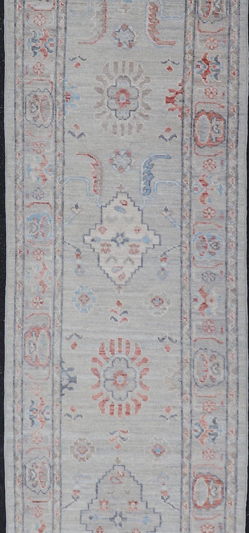 Contemporary Afghan Hand Knotted Oushak with Coral and Blue Motifs on Light Gray Background For Sale