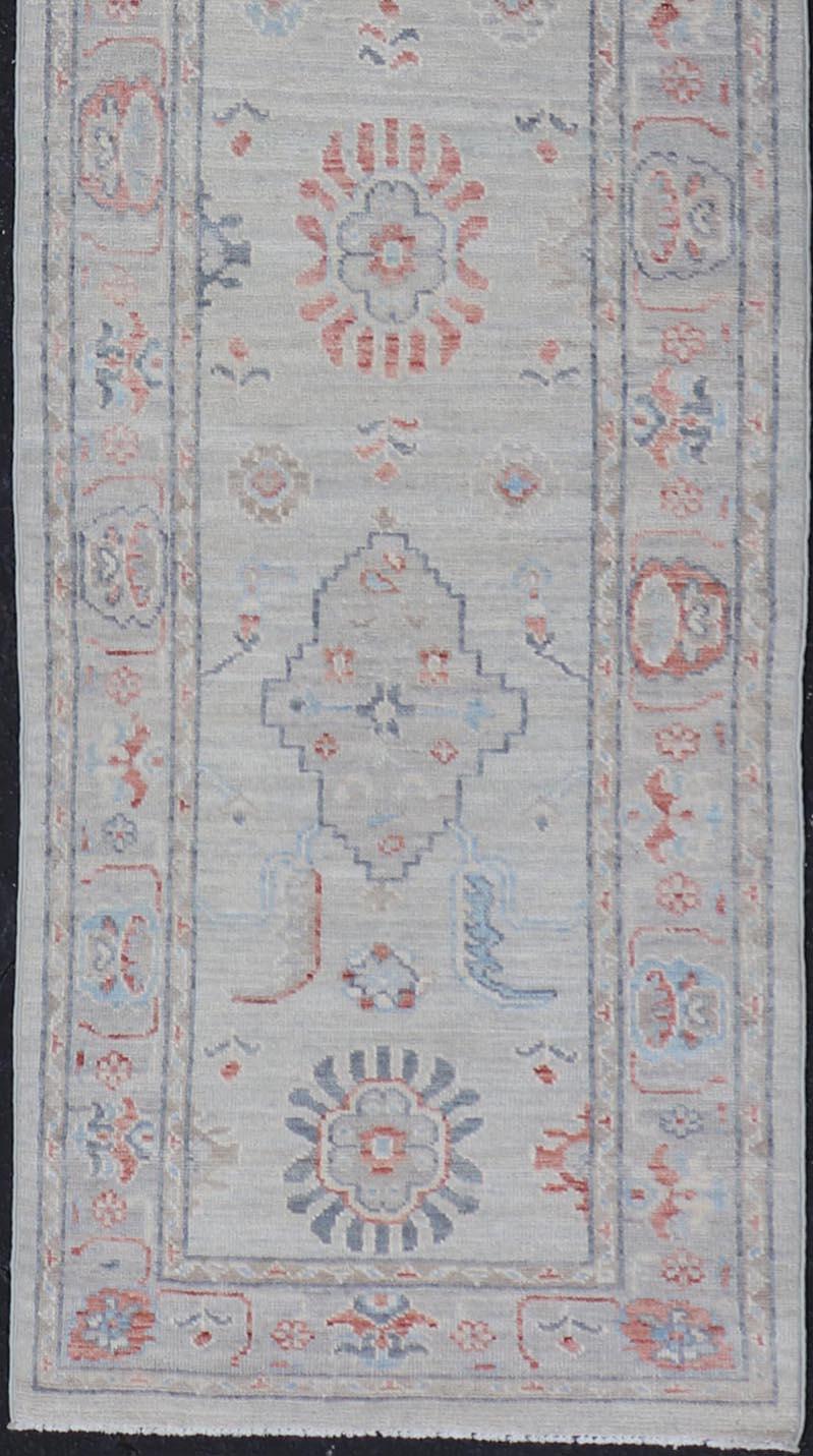 Wool Afghan Hand Knotted Oushak with Coral and Blue Motifs on Light Gray Background For Sale