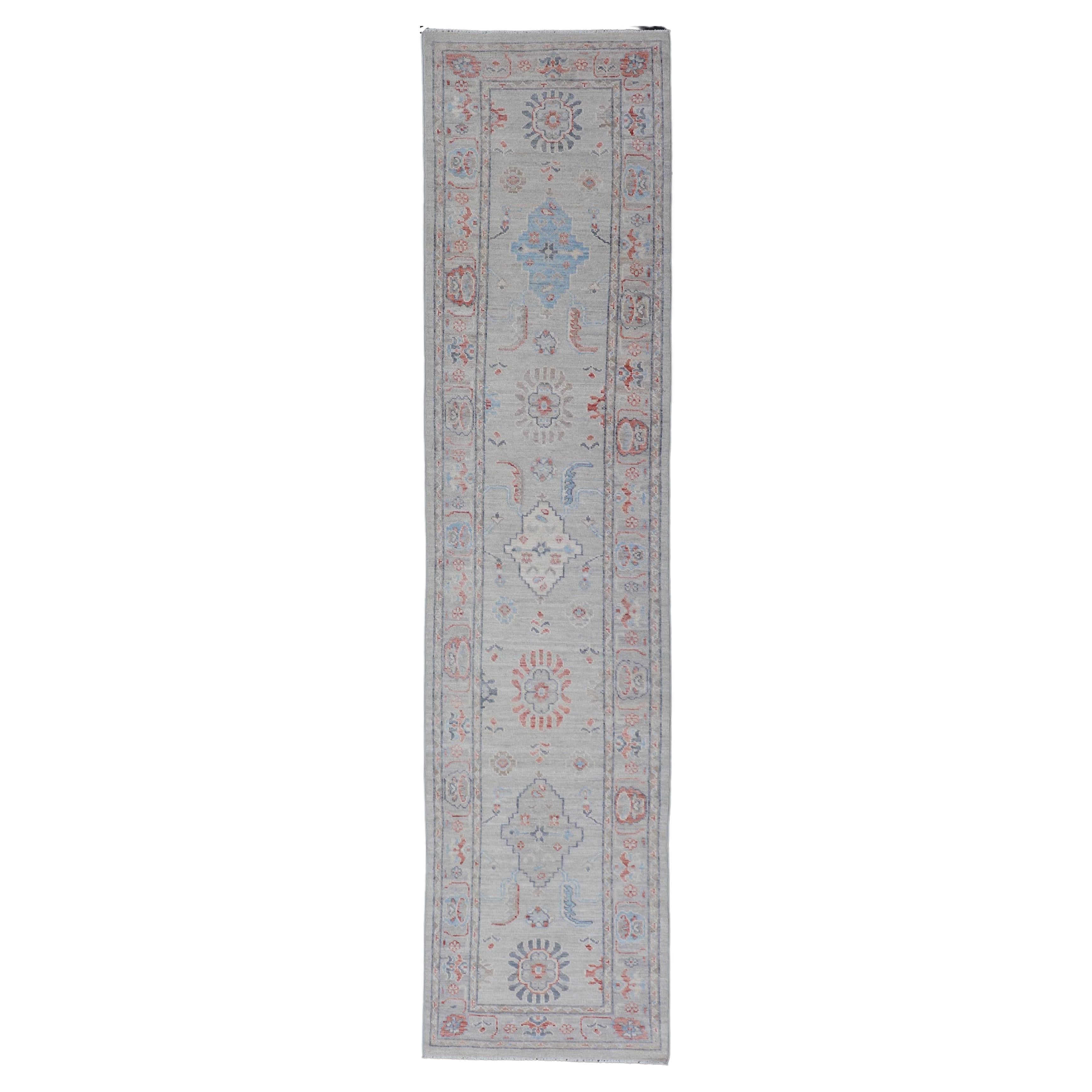 Afghan Hand Knotted Oushak with Coral and Blue Motifs on Light Gray Background For Sale