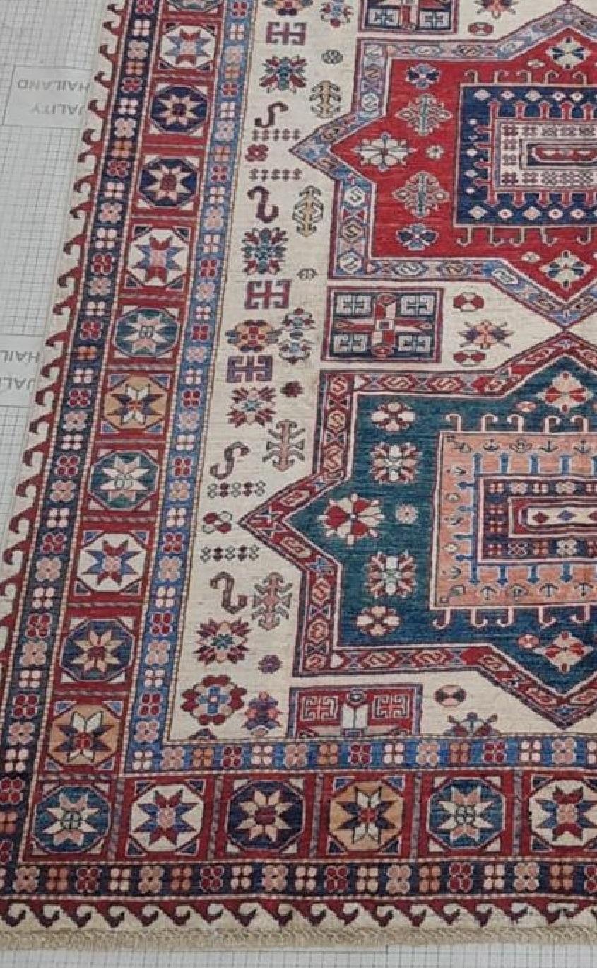 Afghan handmade hand knotted Rug composed of finest quality handspun Merino Wool. The base is cotton. This rug comes from our finest collection of Rugs. Beautiful geometric and floral patterns throughout. Fabulous eye catching colours. The warm