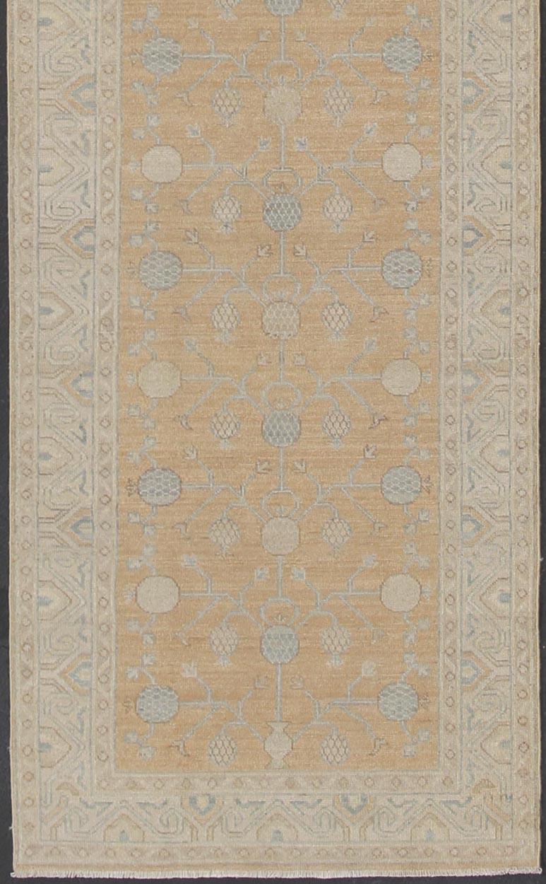 Light Khotan runner with geometric pomegranate Medallions, rug/MP-1903-8800 country of origin / type: Afghanistan / Khotan Keivan Woven Arts 

This Khotan features a geometric all-over design flanked by a repeating pattern in the border. The