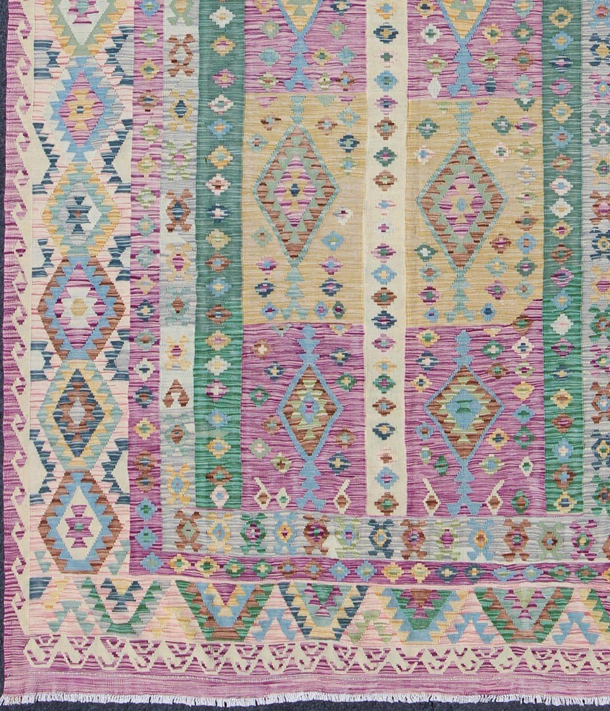 21st century Modern Afghan Flat Weave Kilim Rug in Purple, Lavender, Green, yellow and Cream rug orn-29453, country of origin / type: Afghanistan / Kilim.

This flat-weave Kilim bears a repeating diamond design with other geometric motifs. Set on a