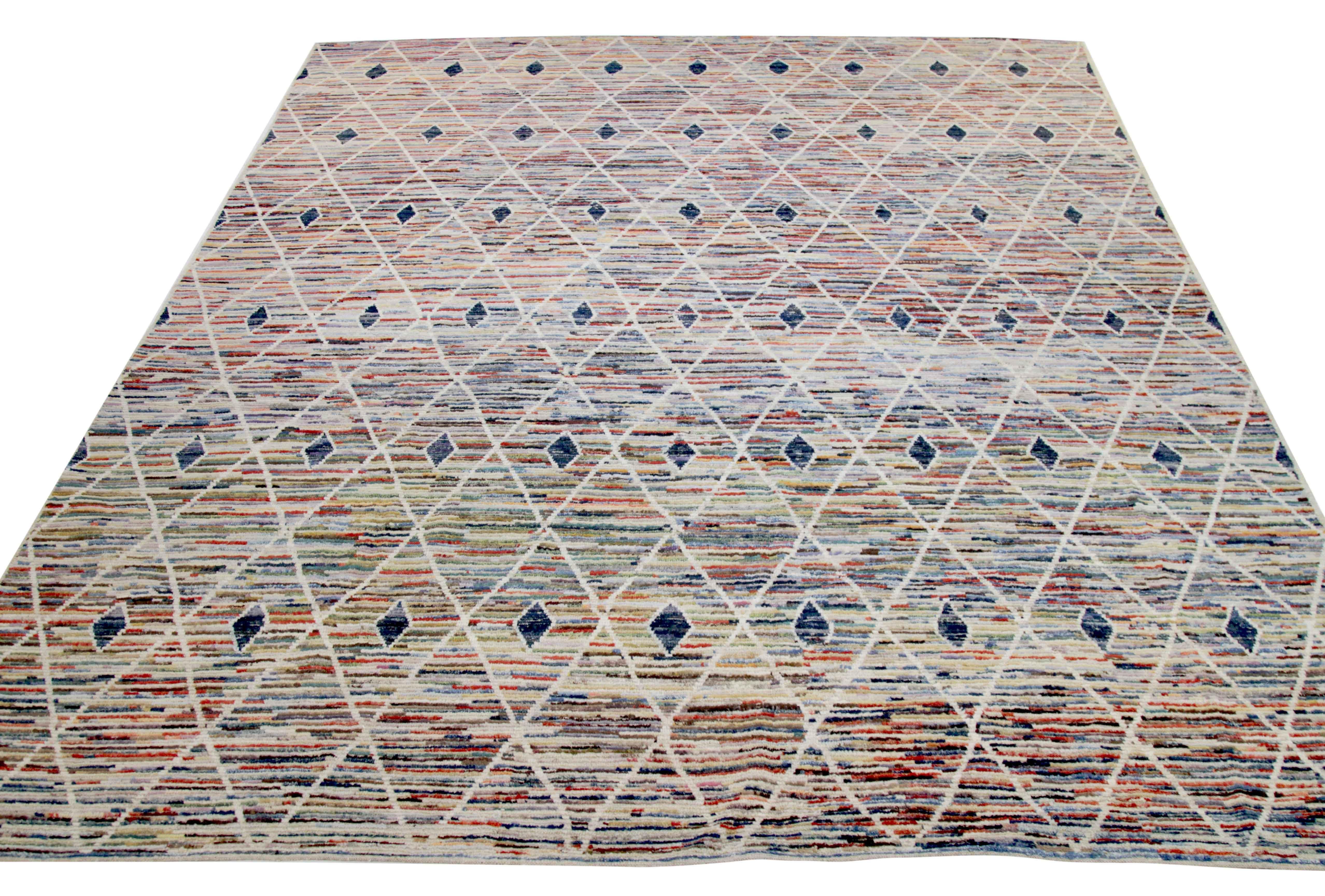 Modern Afghan rug handwoven from the finest sheep’s wool. It’s colored with all-natural vegetable dyes that are safe for humans and pets. This piece is a traditional Afghan weaving featuring a Moroccan inspired design. It’s highlighted by white and