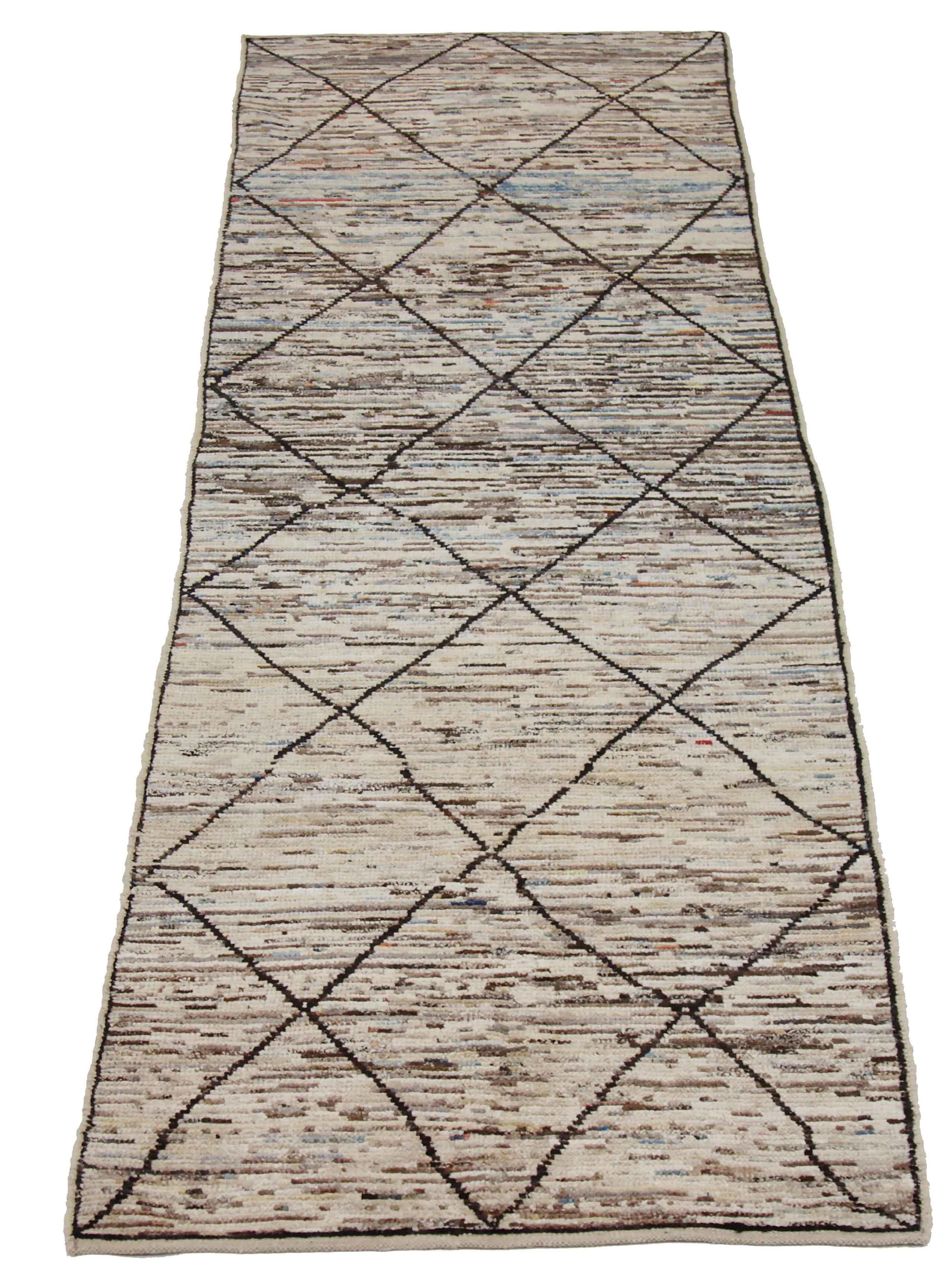 Modern Afghan runner rug handwoven from the finest sheep’s wool. It’s colored with all-natural vegetable dyes that are safe for humans and pets. This piece is a traditional Afghan weaving featuring a Moroccan inspired design. It’s highlighted by