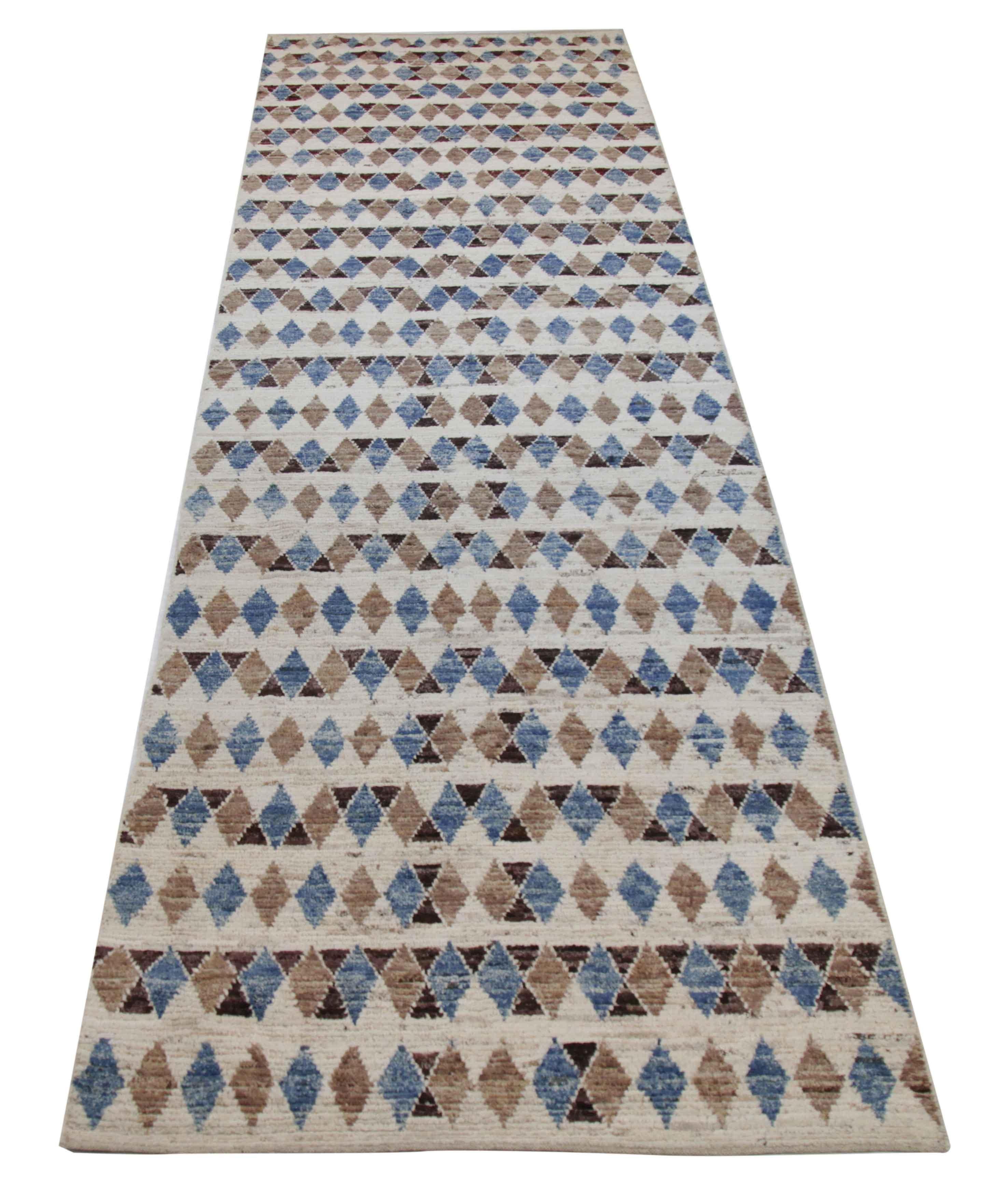 Modern Afghan runner rug handwoven from the finest sheep’s wool. It’s colored with all-natural vegetable dyes that are safe for humans and pets. This piece is a traditional Afghan weaving featuring a Moroccan inspired design. It’s highlighted by