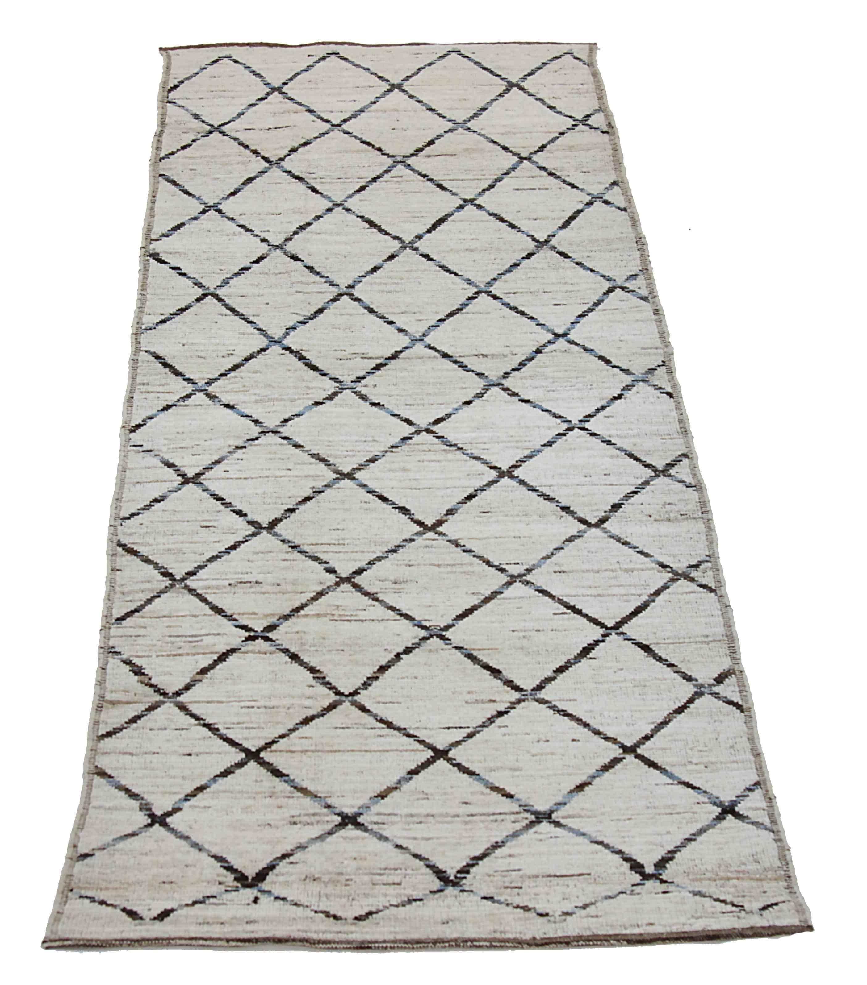 Modern Afghan runner rug handwoven from the finest sheep’s wool. It’s colored with all-natural vegetable dyes that are safe for humans and pets. This piece is a traditional Afghan weaving featuring a Moroccan inspired design. It’s highlighted by