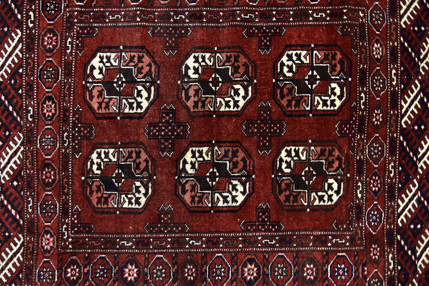 This oriental rug was made in Afghanistan during the 1970s. These rugs are hand knotted by Turkmen people in central and northern Afghanistan. Natural dyes, usually vegetable plant dyes, are used to obtain rich colors. The rugs are mostly medium