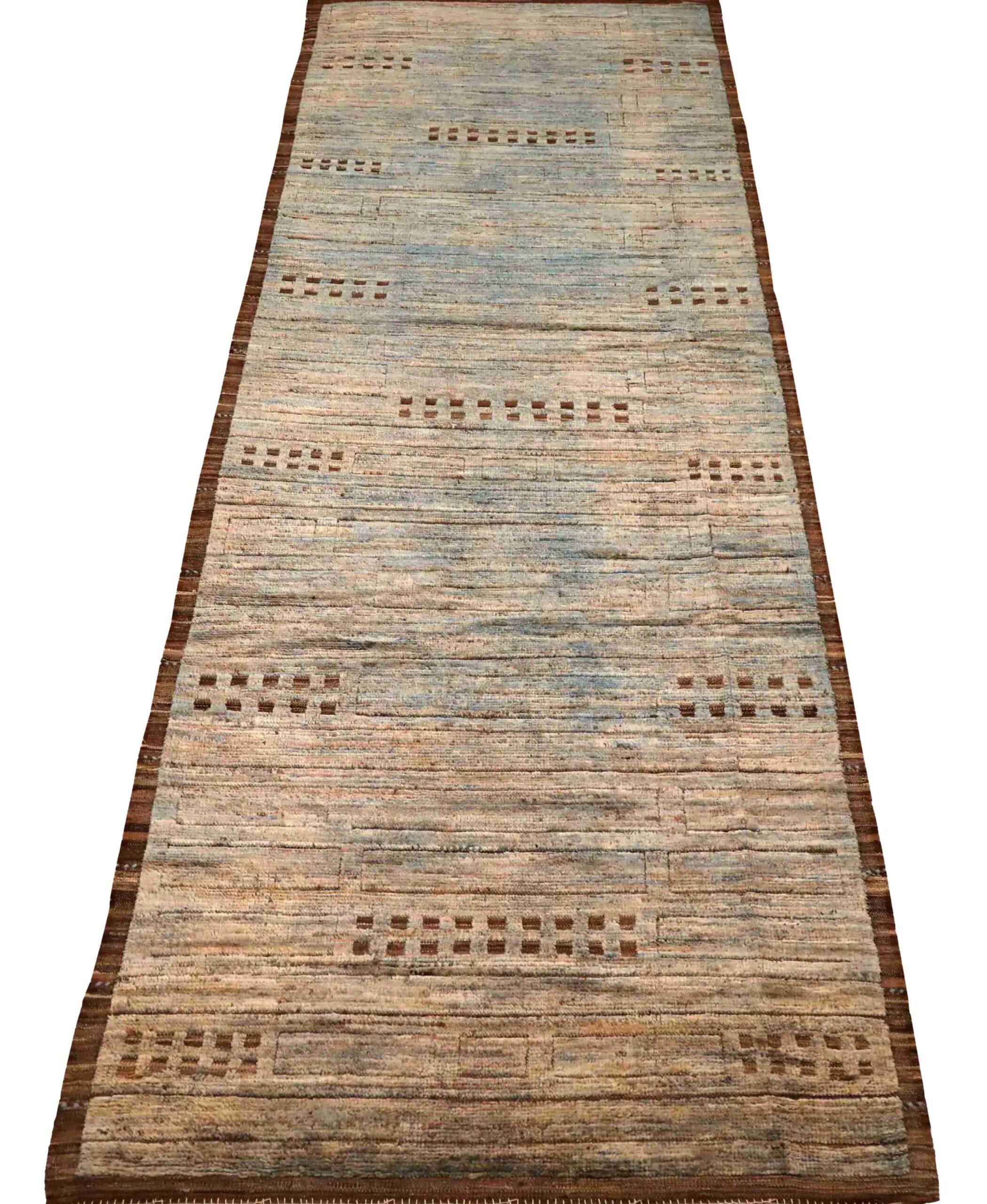 Descubre la elegancia de la alfombra de corredor marroquí Afganistán de Circa 1990. Diseñado con lana y azul-marrón-marfil, este diseño exclusivo es perfecto para realzar tu espacio.