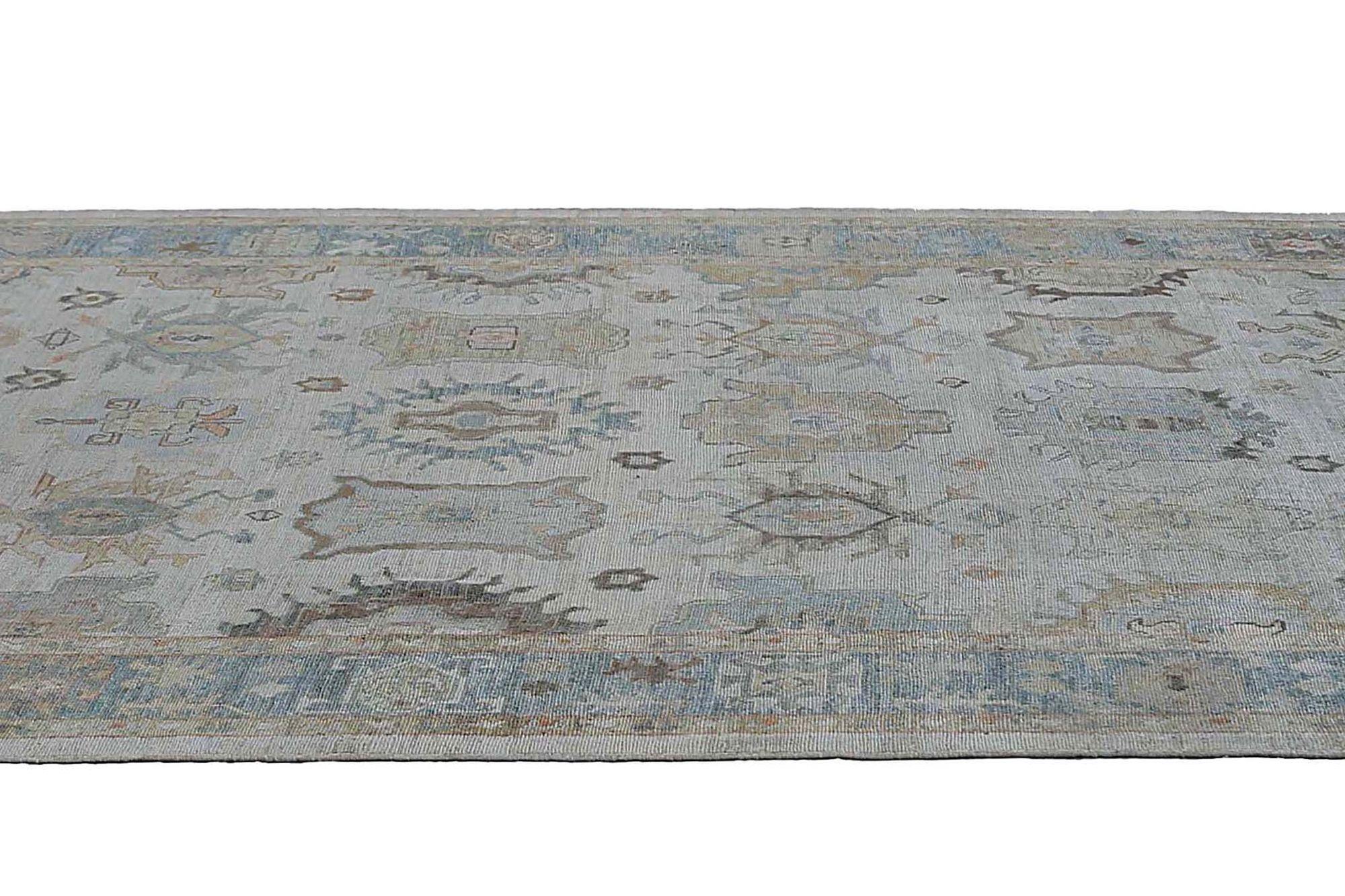 Afghan Oushak Rug: Muted Grey-Blue & Earthy Floral Design

A Field of Subtle Grandeur and Intricate Detail
This captivating Afghan Oushak area rug immediately commands attention. Its expansive field, in a sophisticated muted grey-blue, provides a