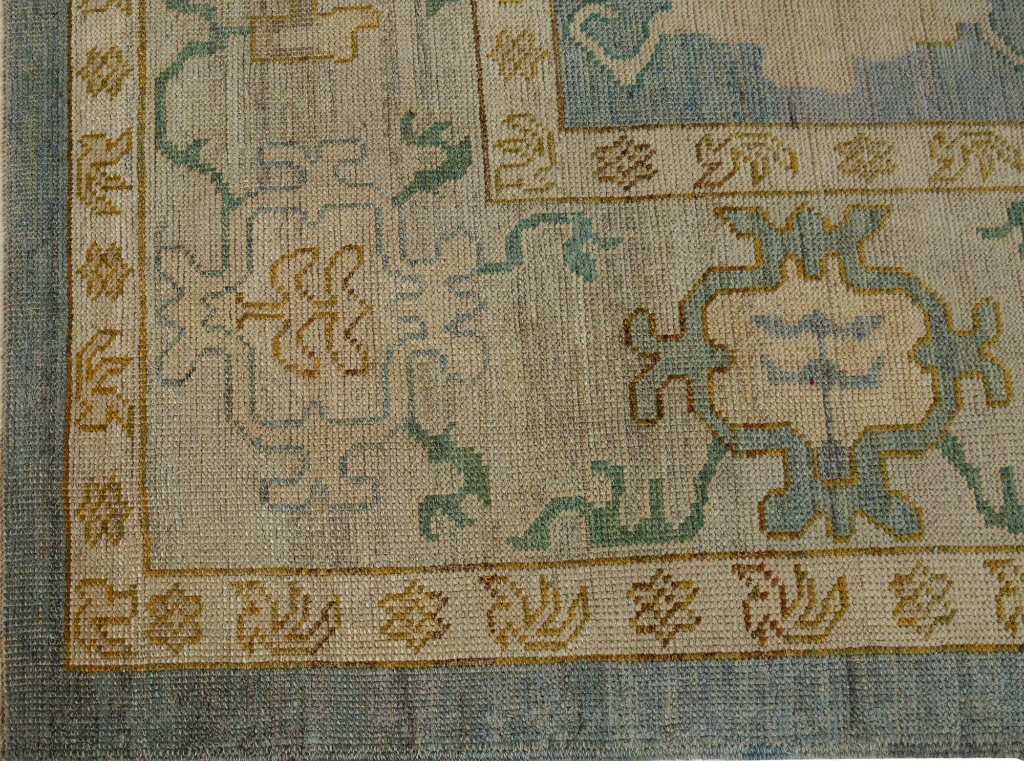 Stunning Hand-Knotted Turkish Oushak Style Area Rug  Blue & Gold Wool
Discover the perfect centerpiece for your home with this exquisite hand-knotted Turkish Oushak style area rug. Masterfully crafted by artisans in India, this piece blends the