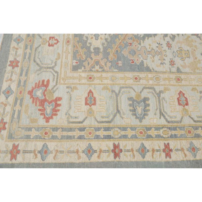 Afghan Oversize Rug: Muted Blue Sultanabad

A Masterpiece Unveiled
This magnificent Afghan Sultanabad rug, measuring 12 ft 3 in x 18 ft 6 in, stands as a stunning testament to centuries of celebrated Central Asian textile artistry. Its plush surface