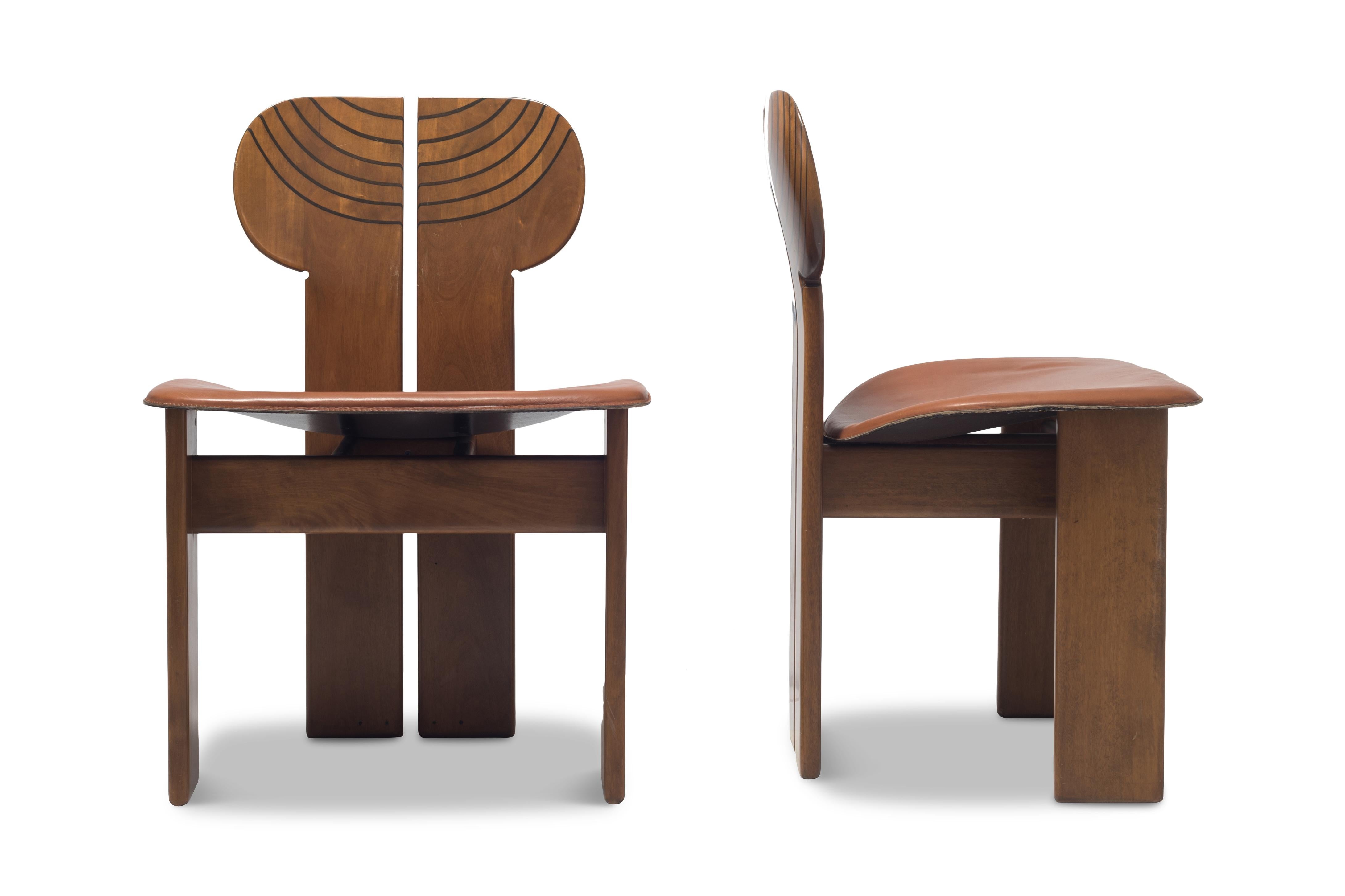 Africa chairs by Afra & Tobia Scarpa for Maxalto, Italy, 1975. 
Set of four
The sculptural chairs show many beautiful details, such as the ebonized layers in the backrest, the elegant curve in the cognac leather seat, or the brass support in the