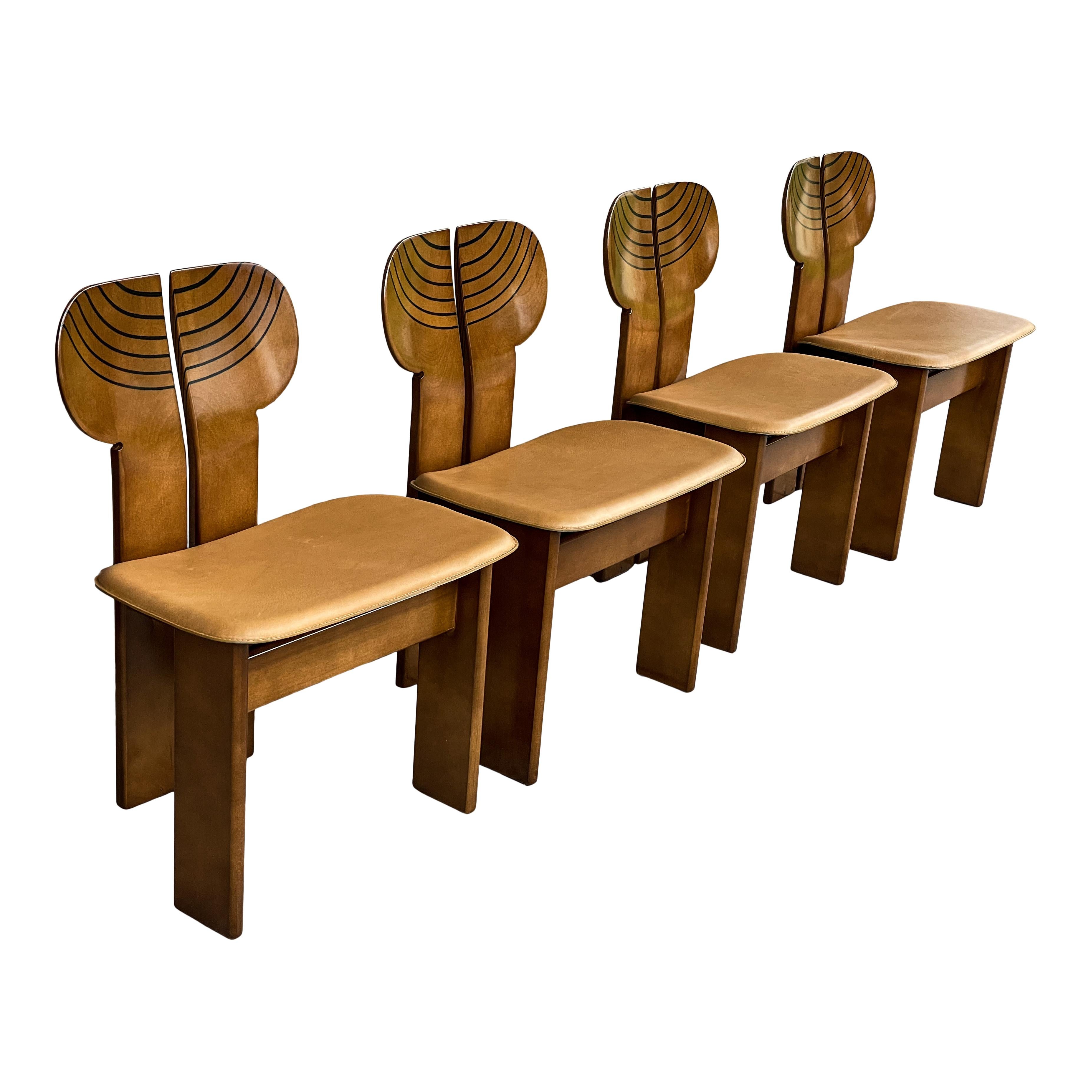 Set of four Africa dining chairs, designed by Afra and Tobia Scarpa and produced by the Italian manufacturer Maxalto in 1976.
They feature a clear walnut briar structure and a cognac leather seat.
Fully restored in Italy.

The main protagonist of