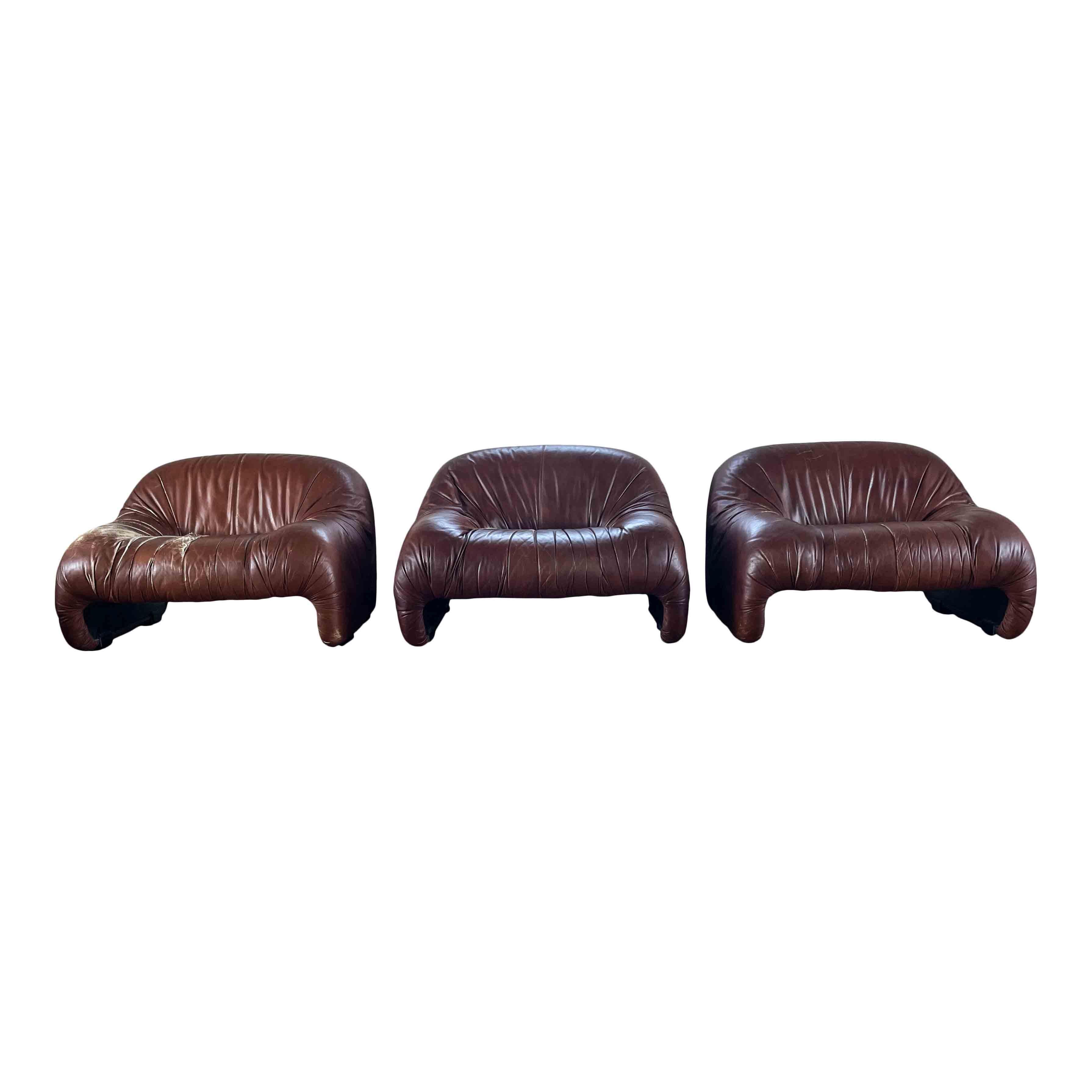 Set composed of three Bonanza lounge chairs, designed by Afra and Tobia Scarpa and produced by the Italian manufacturer C&B Italia (now B&B Italia), in 1970.

The set features a chocolate brown leather upholstery, foam padding, and plastic