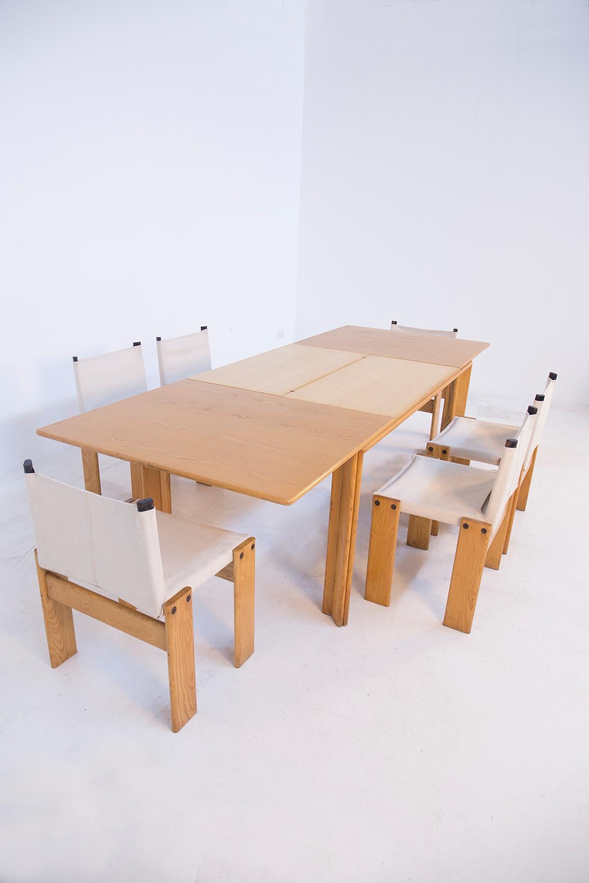 Extendable dining table by Afra & Tobia Scarpa model Monk in beechwood. The table by means of its mechanism allows the two sides of the wooden top to be extended, where inside there are two other pull-out shelves that allow the table to be extended.