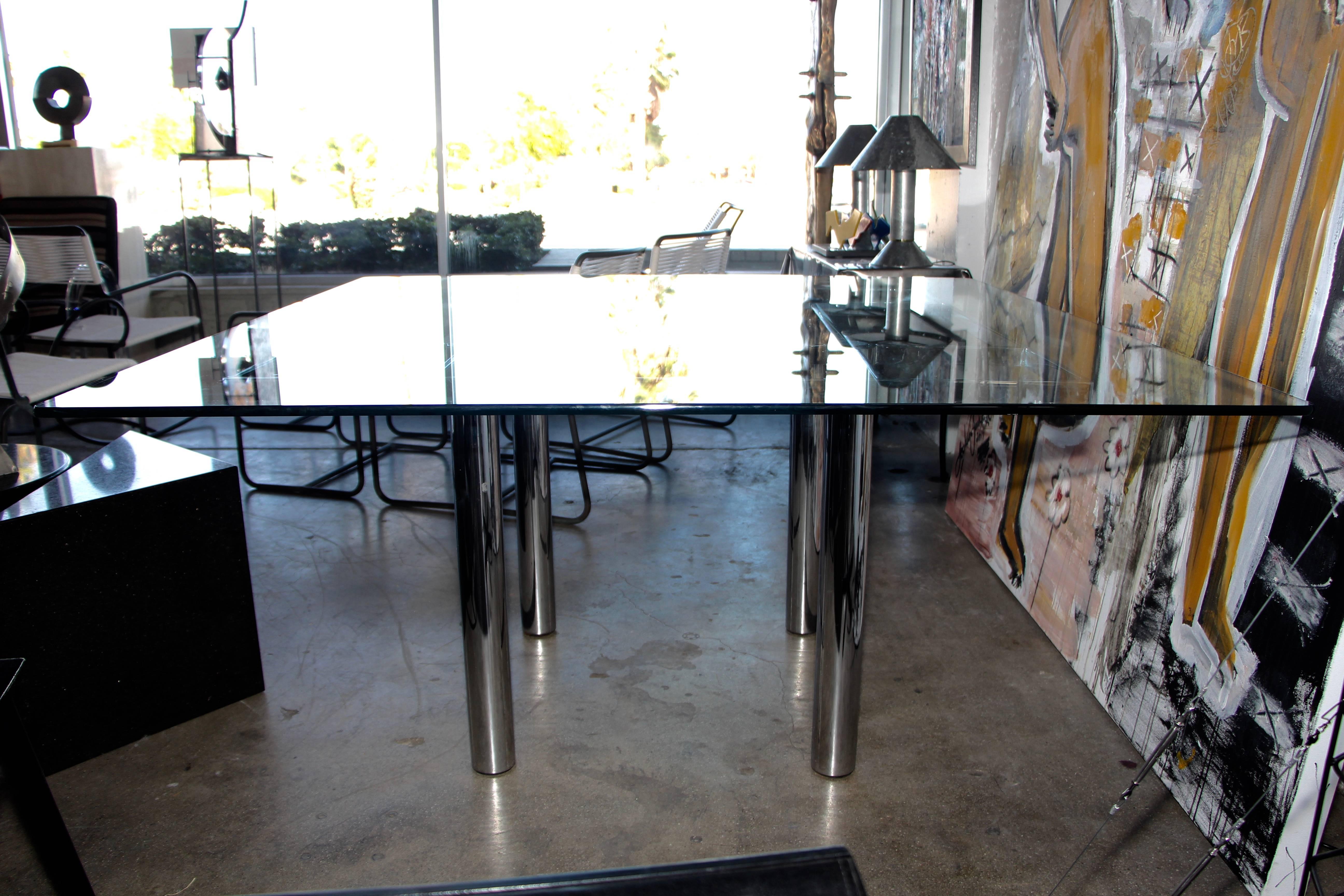 A nice 60 inch square dining table designed by Afra and Tobia Scarpa for Knoll. It features a 60 inch square glass top, that has some scratches. Minor marks to the chrome as well.