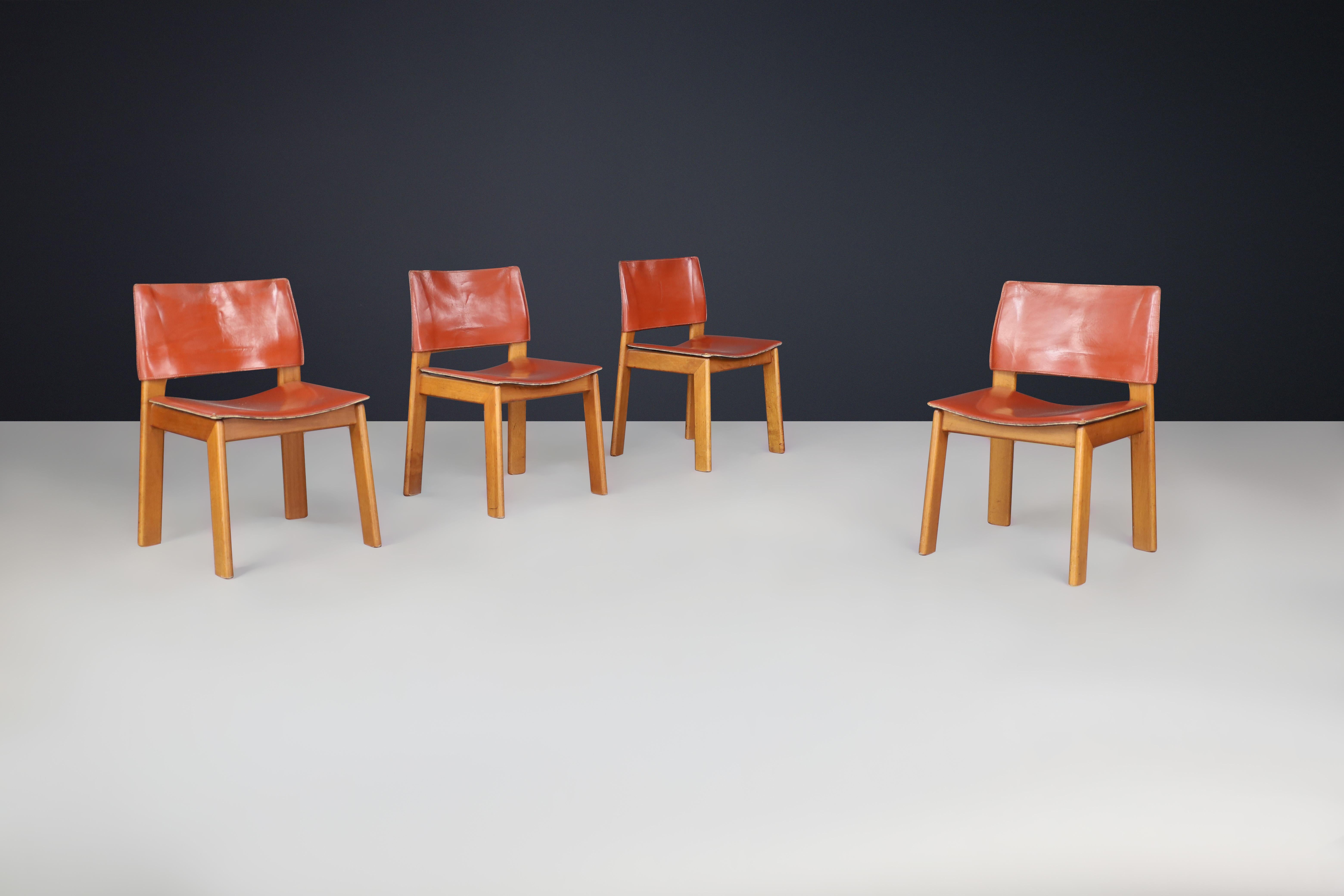 Afra and Tobia Scarpa leather dining room chairs for Molteni Italy 1970s
 
Afra and Tobia Scarpa designed a set of four dining chairs for Molteni in the 1970s. The chairs are made of English red leather and walnut. Despite their lightweight