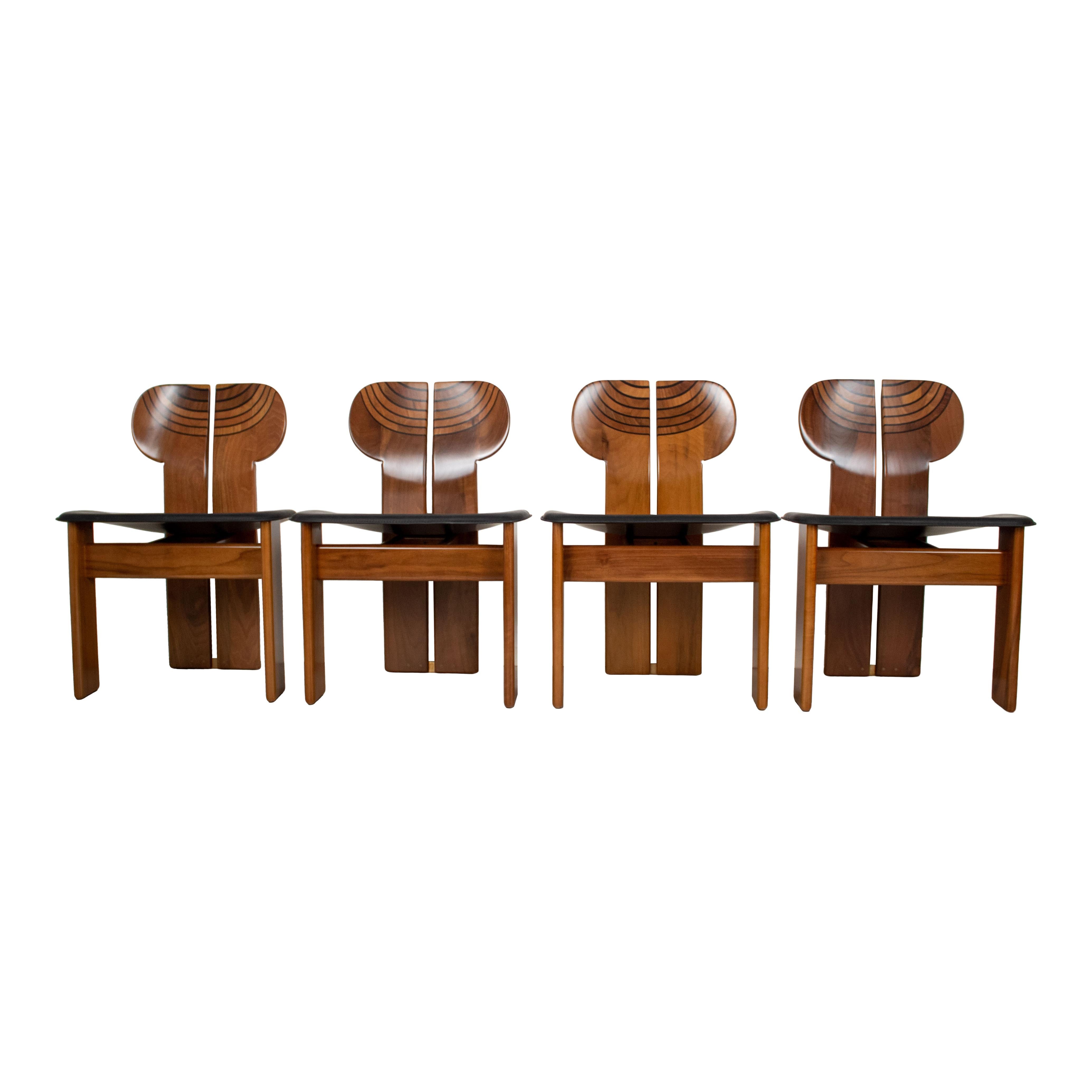 Set of four Africa dining chairs, designed by Afra and Tobia Scarpa and produced by the Italian manufacturer Maxalto in 1976.
They feature a clear walnut briar structure and a black leather seat.
Fully restored in Italy.

The main protagonist of the