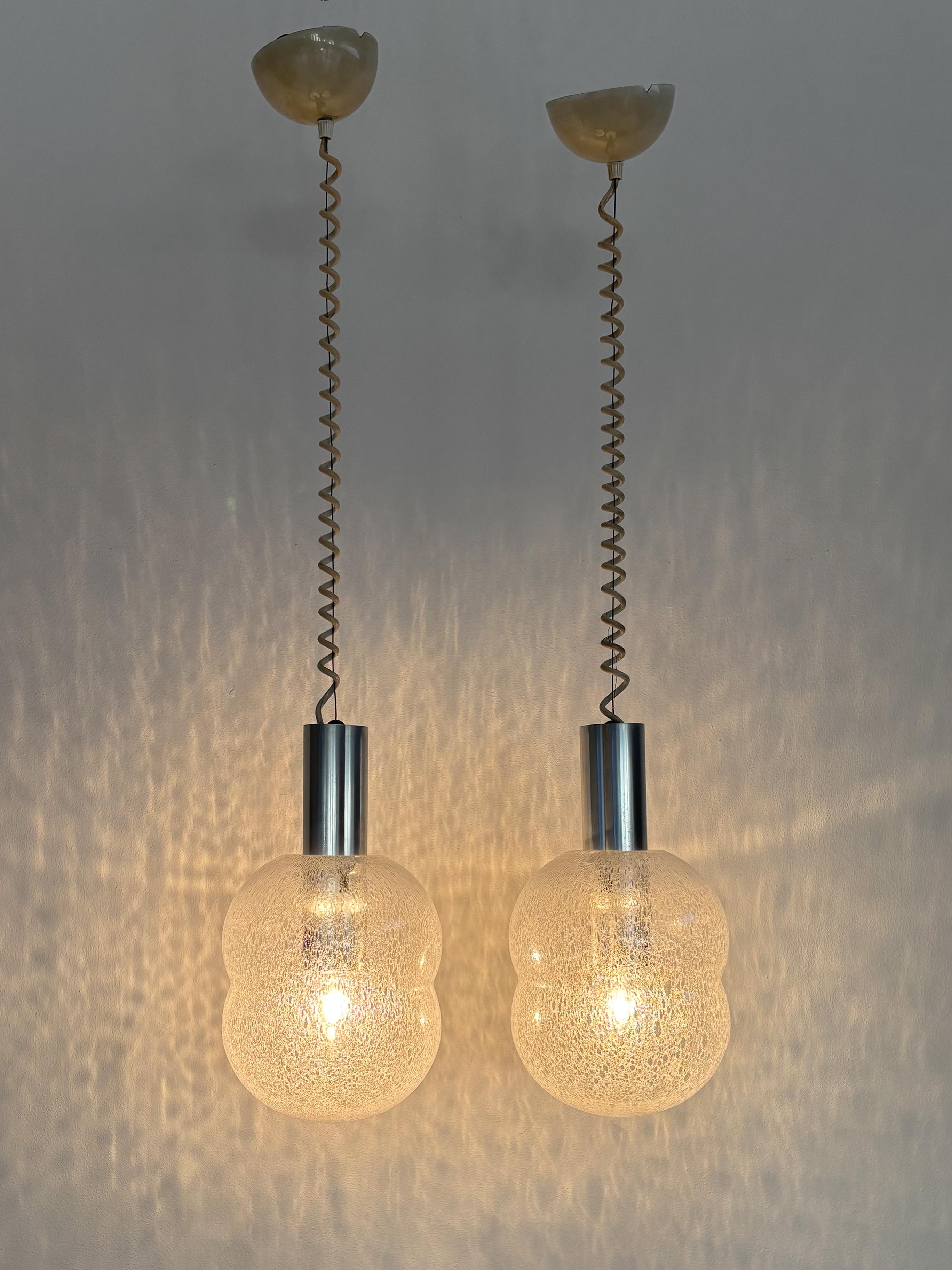 Italian midcentury modern design set of two pendant lamps “Bilobo” model designed by Afra e Tobia Scarpa and produced by Flos from 1960s with diffused light diffuser made of thick Murano bubble glass and anodised aluminium support with spring-loaded