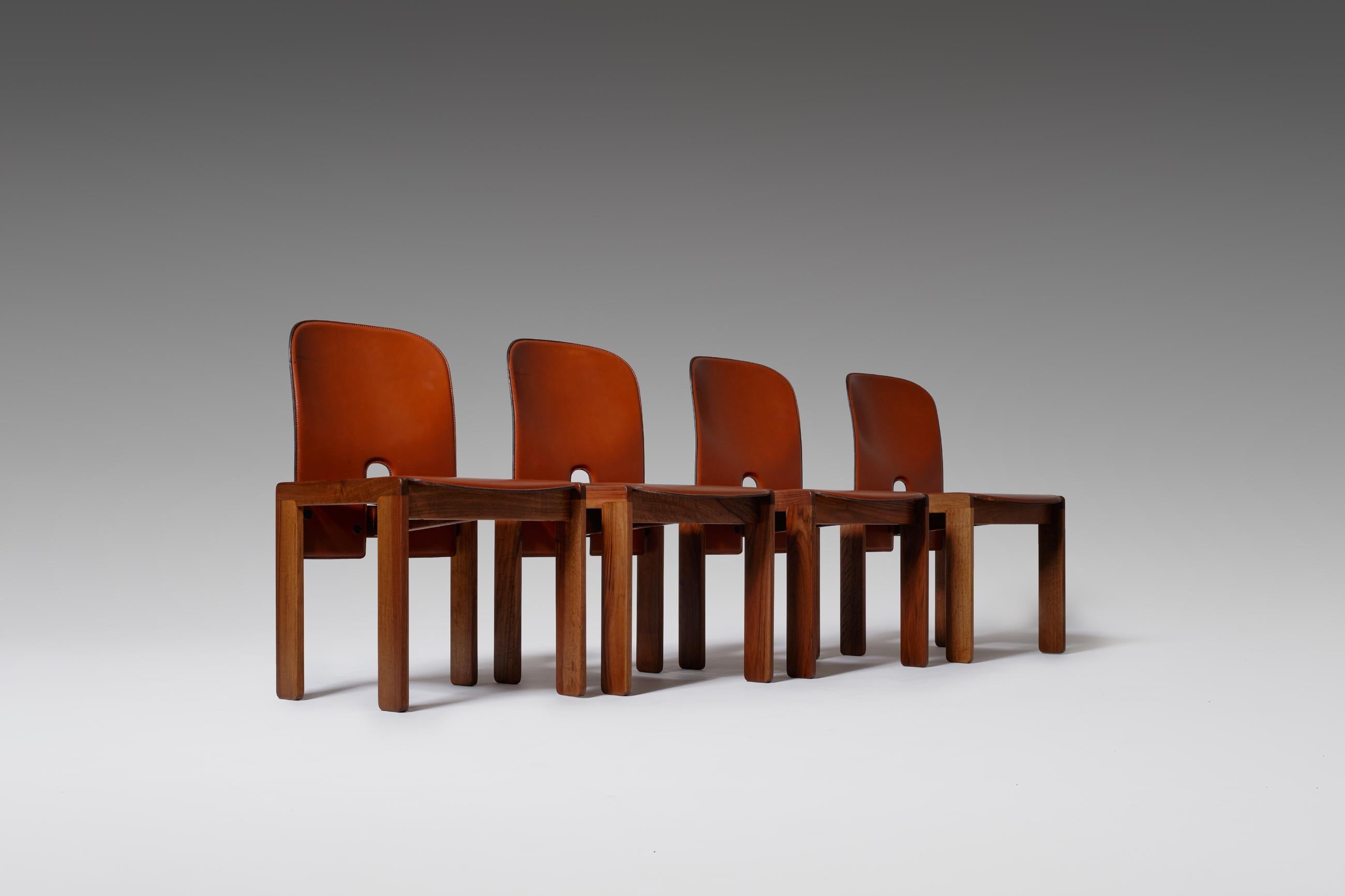 Set of four ‘121’ dining chairs by Afra & Tobia Scarpa for Cassina, Italy 1965. A minimal and striking design with strong graphic lines and interesting details resulting in an architectural appearance. The frames are constructed out of solid walnut