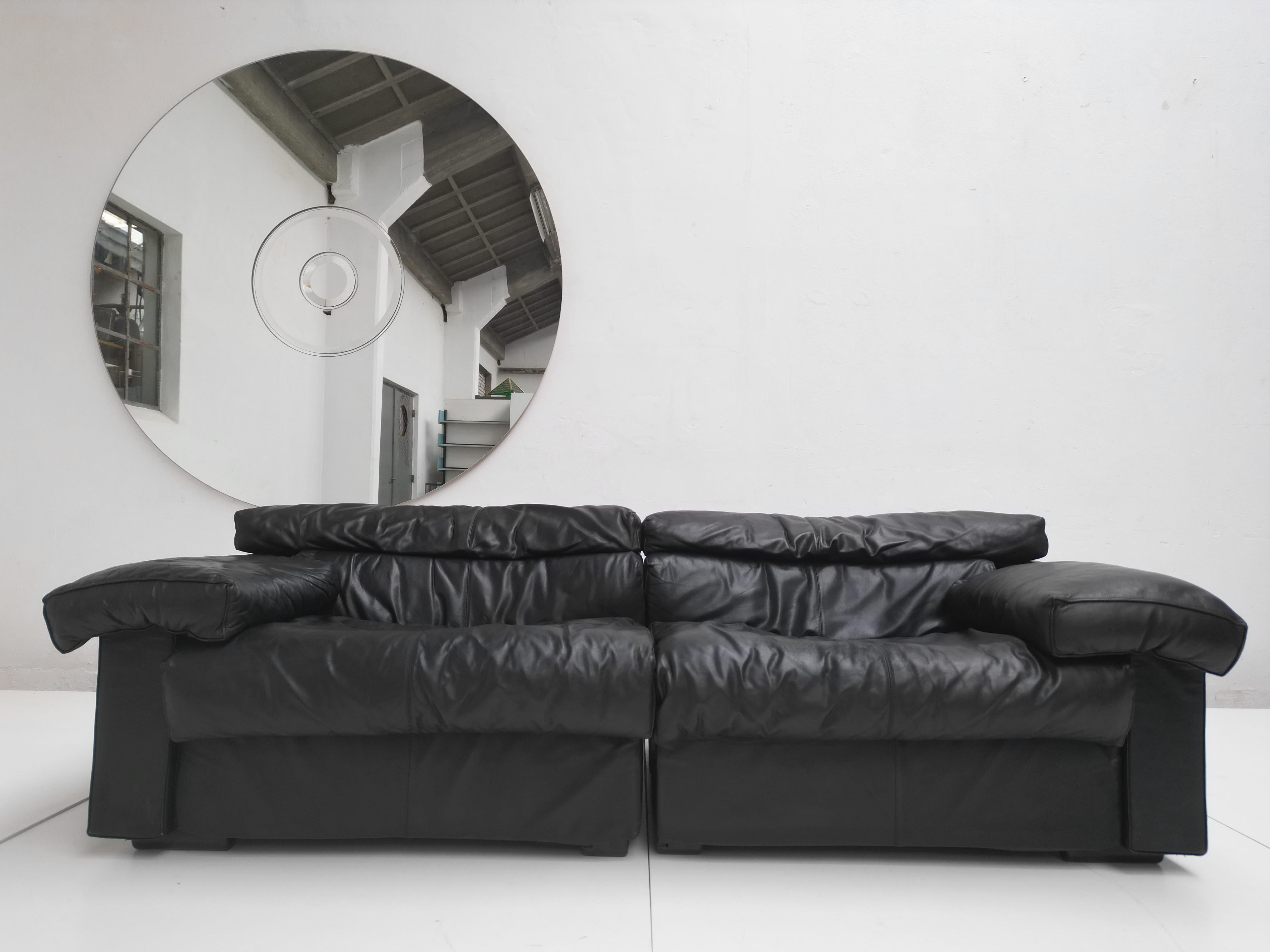 This black leather 2 seater + matching table  version 'Erasmo' sectional sofa was produced in 1976 and designed by Afra & Tobia Scarpa for B&B Italia in 1973

The black laminated table block was most likely custom made to match the 2 