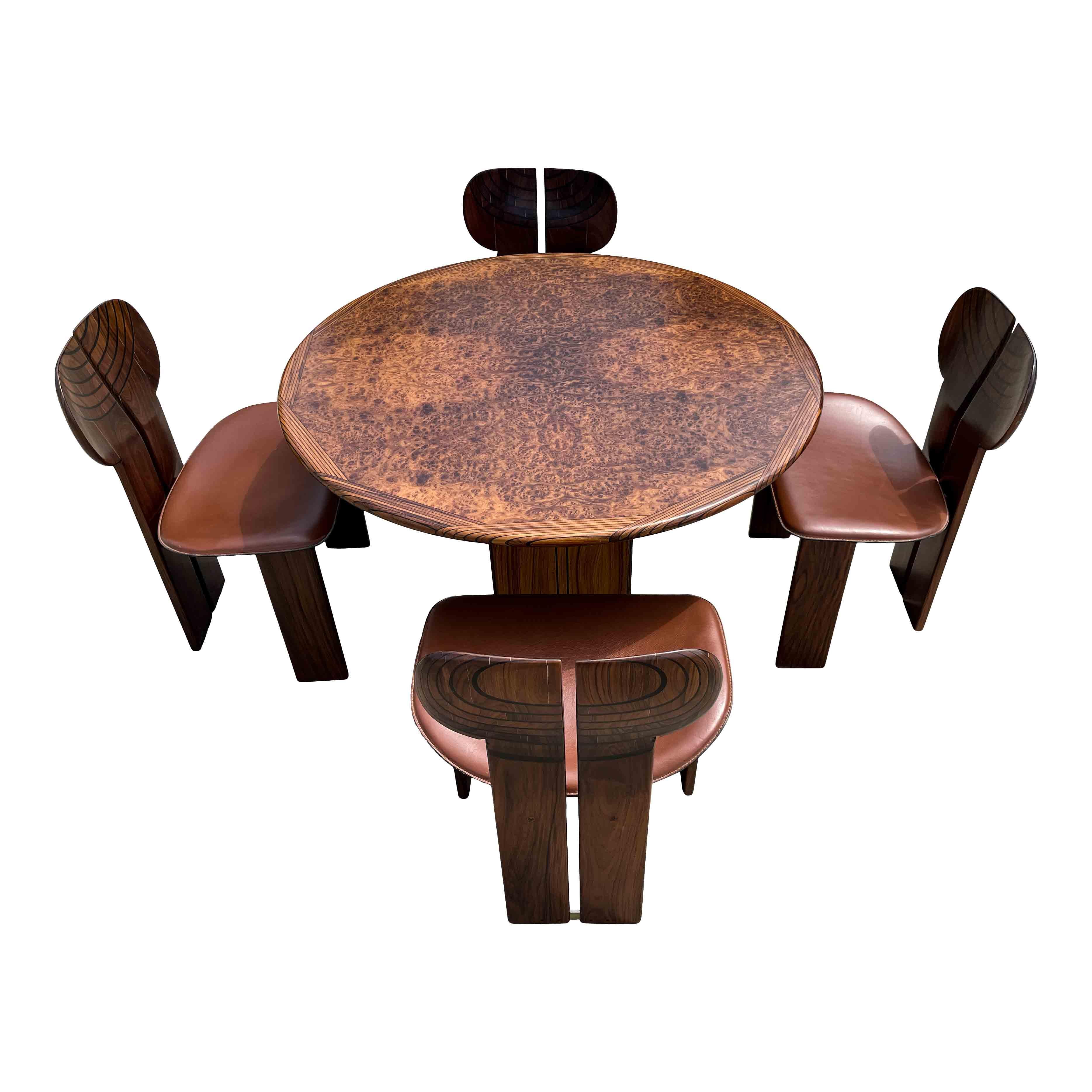 A dining set composed of four “Africa” dining chairs and an “Artona” table, designed by Afra and Tobia Scarpa for Maxalto in 1975.

Made of walnut, burl, and ebony.

Originally hand-finished and assembled one by one, “Africa” presents a support