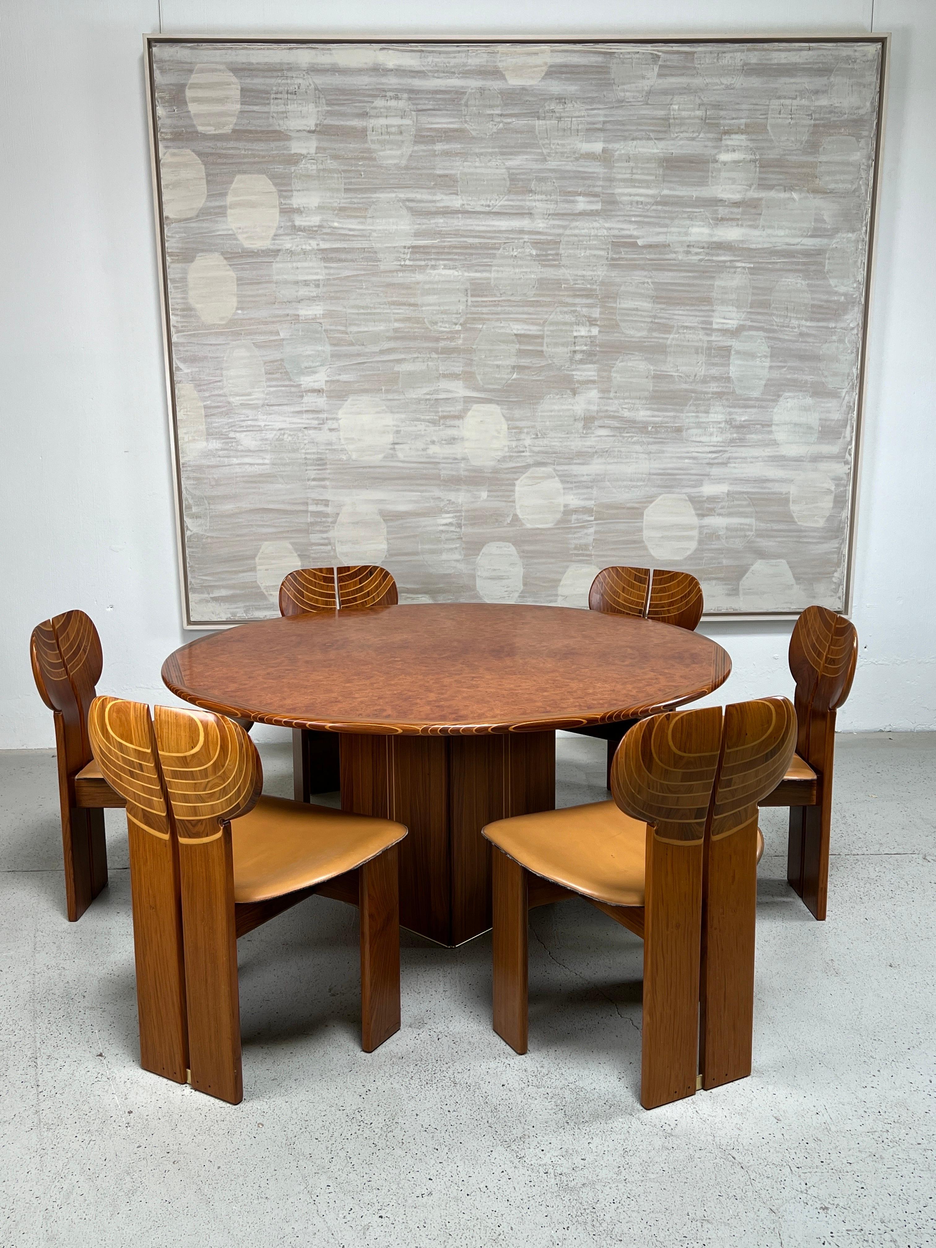 Dining table and six  'Africa' chairs by Afra & Tobia Scarpa for Maxalto. Incredible all original set made of rosewood, walnut and other exotic woods. Beautifully patinated leather seats and brass details. 