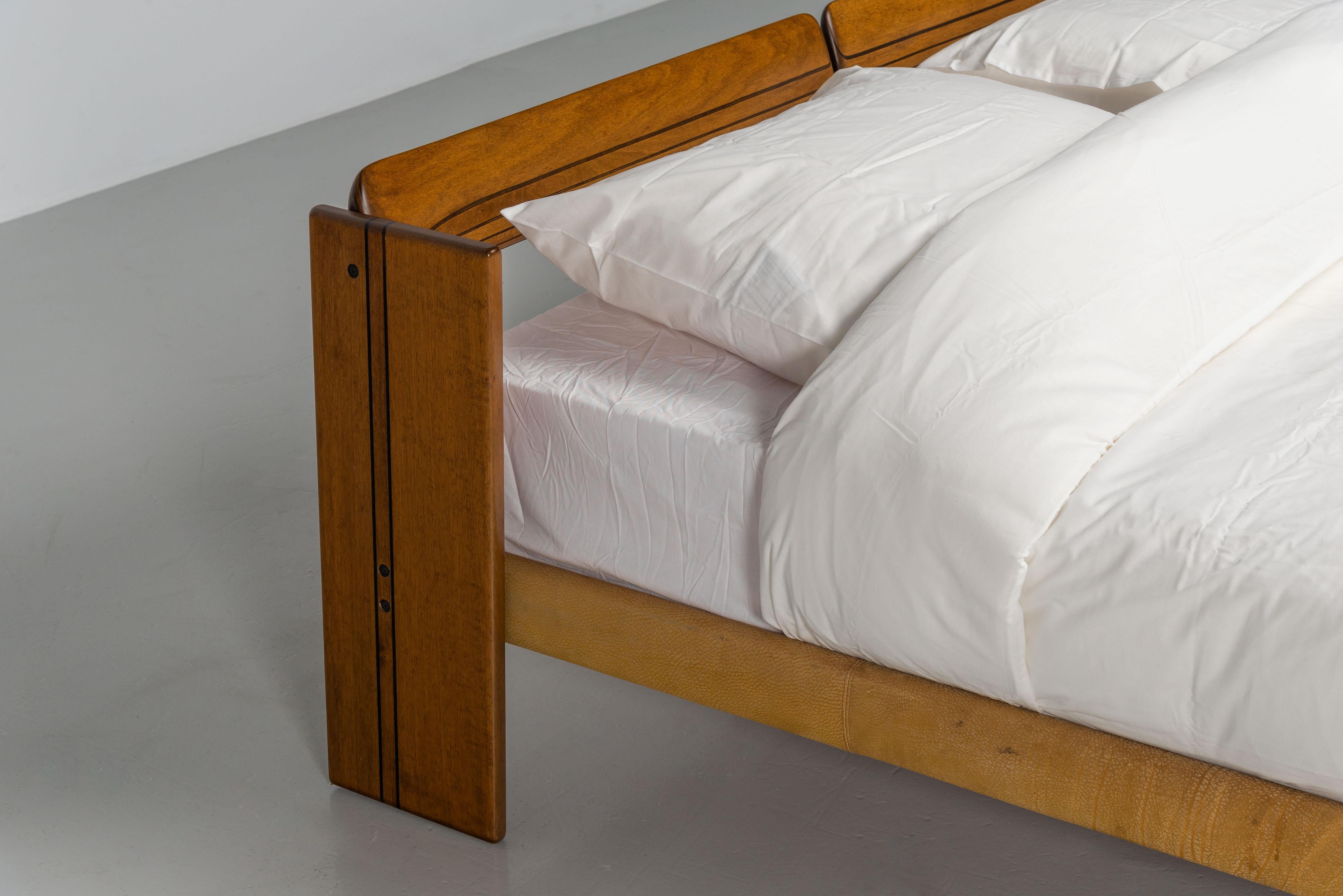 Amazing kingsized bed from the Artona series designed by Afra & Tobia Scarpa and manufactured by Maxalto in Italy in 1975. It's made from walnut wood with ebony details. This series is well-known for its fantastic woodwork and high quality. The