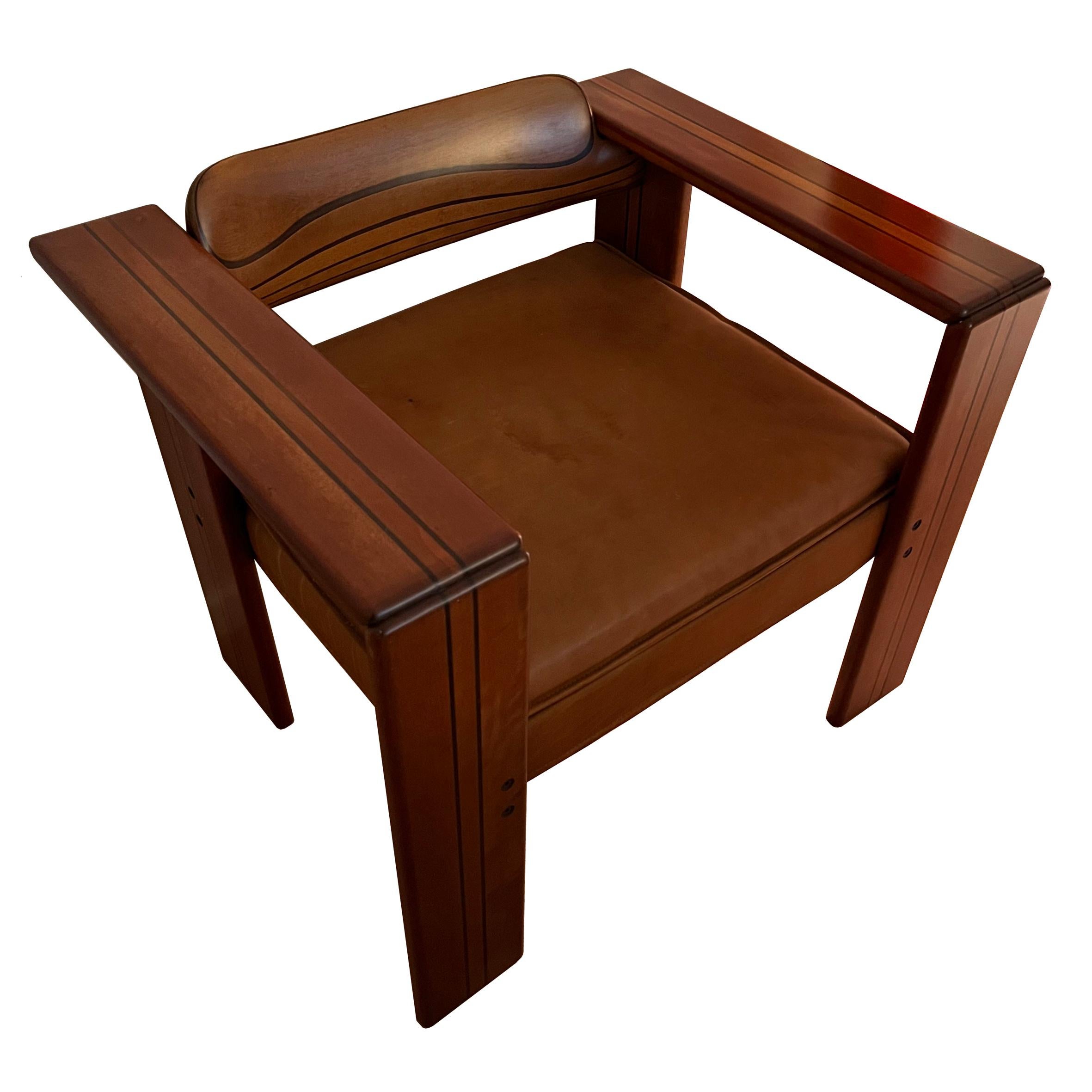 Afra & Tobia Scarpa (1935-2011 & 1935-)

Artona 

A pair of walnut wood and brown leather armchairs, each with rectangular armrests on four conforming feet with a curved back on square leather seat and cushion.
Manufactured by