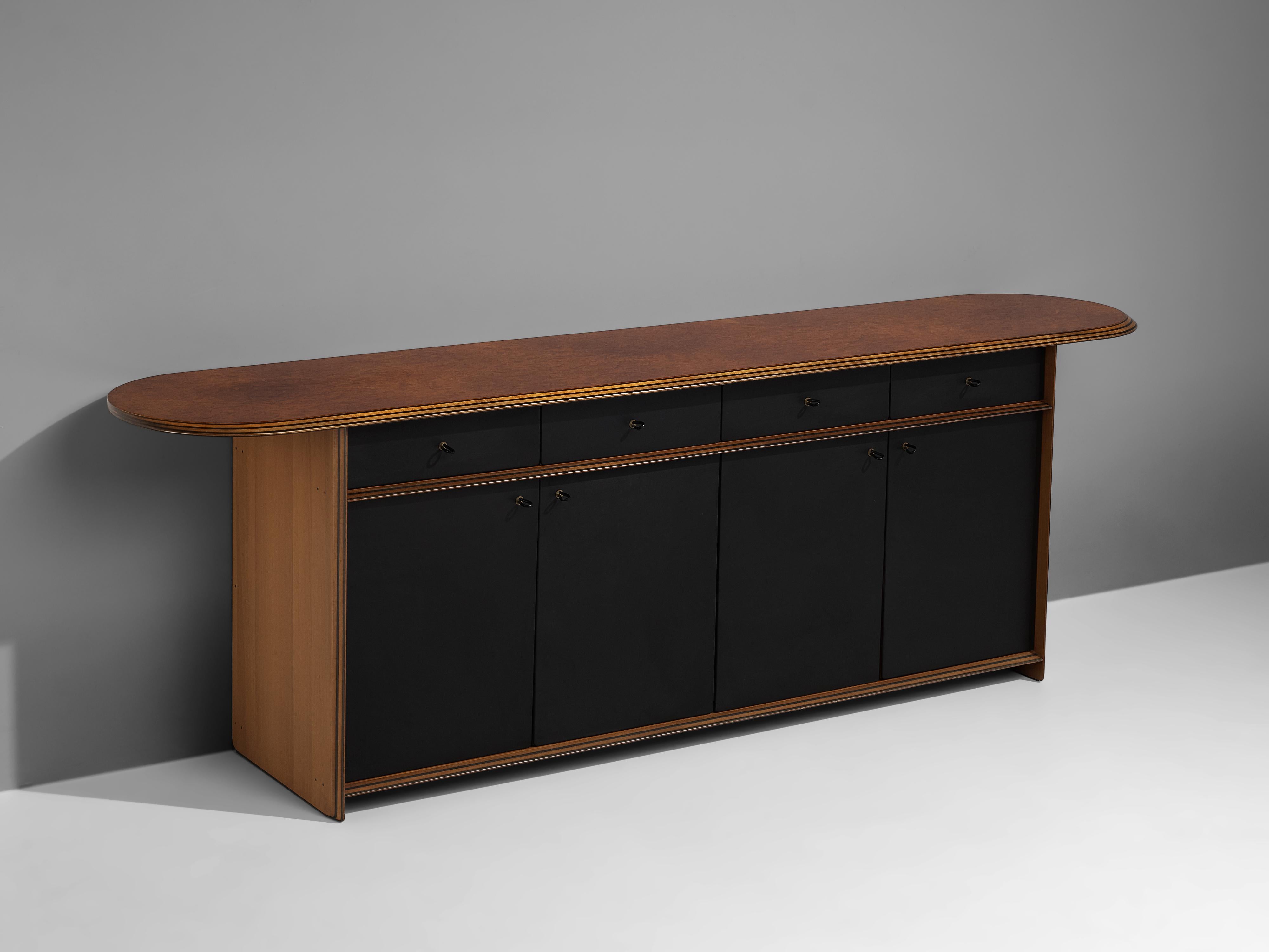 Afra & Tobia Scarpa, sideboard, walnut, leather, Italy, 1970s

This sideboard with a leather front is designed as part of the ‘Artona’ line by Afra & Tobia Scarpa. It features a top with vivid burl wood and overhanging round ends. Four drawers and