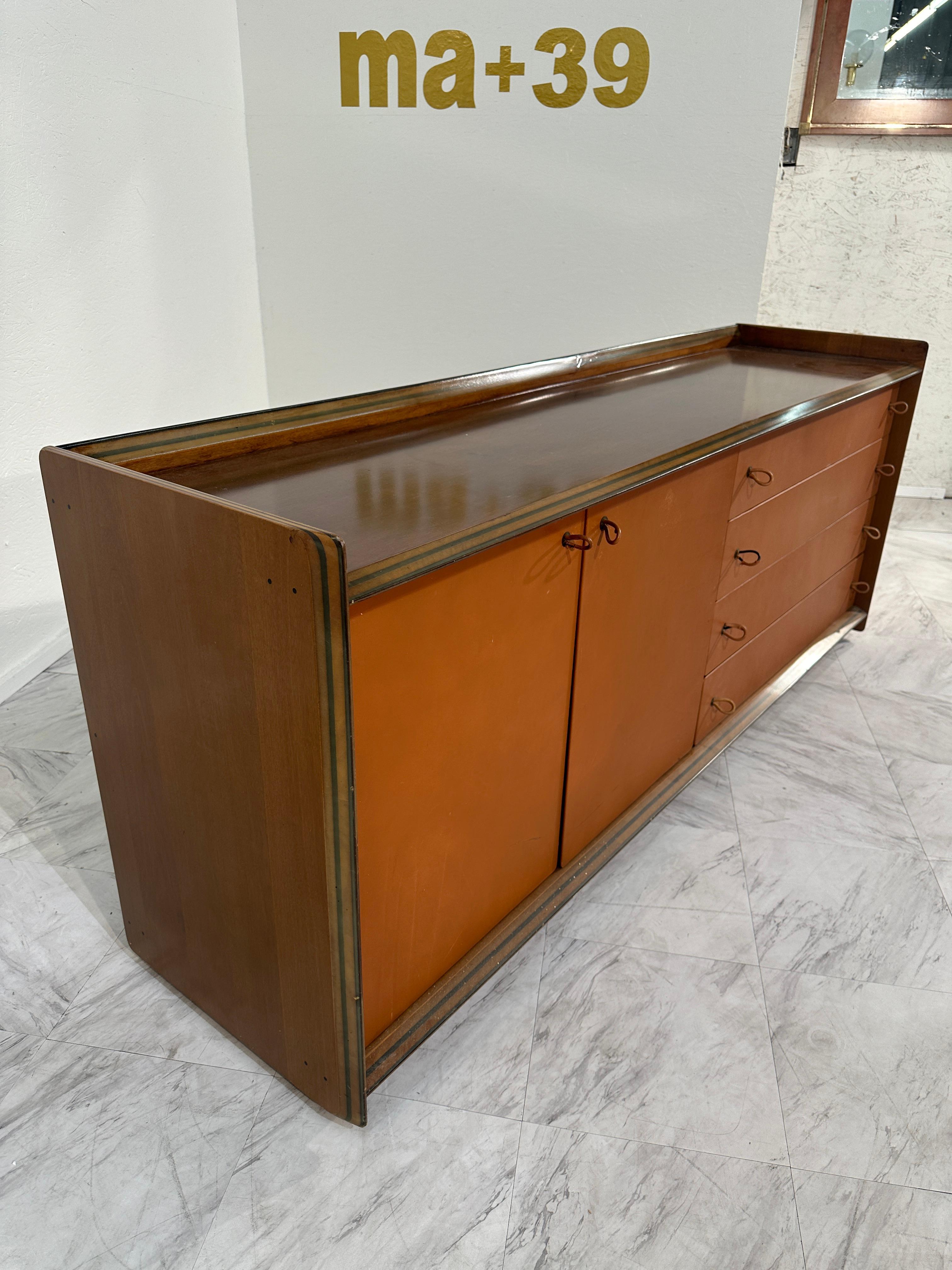 Designed by Afra and Tobia Scarpa for the Artona line by Maxalto, this 1975 sideboard features a walnut frame with a leather front. The Artona collection was the first line produced by Maxalto, a high-end division of B&B Italia, focusing on