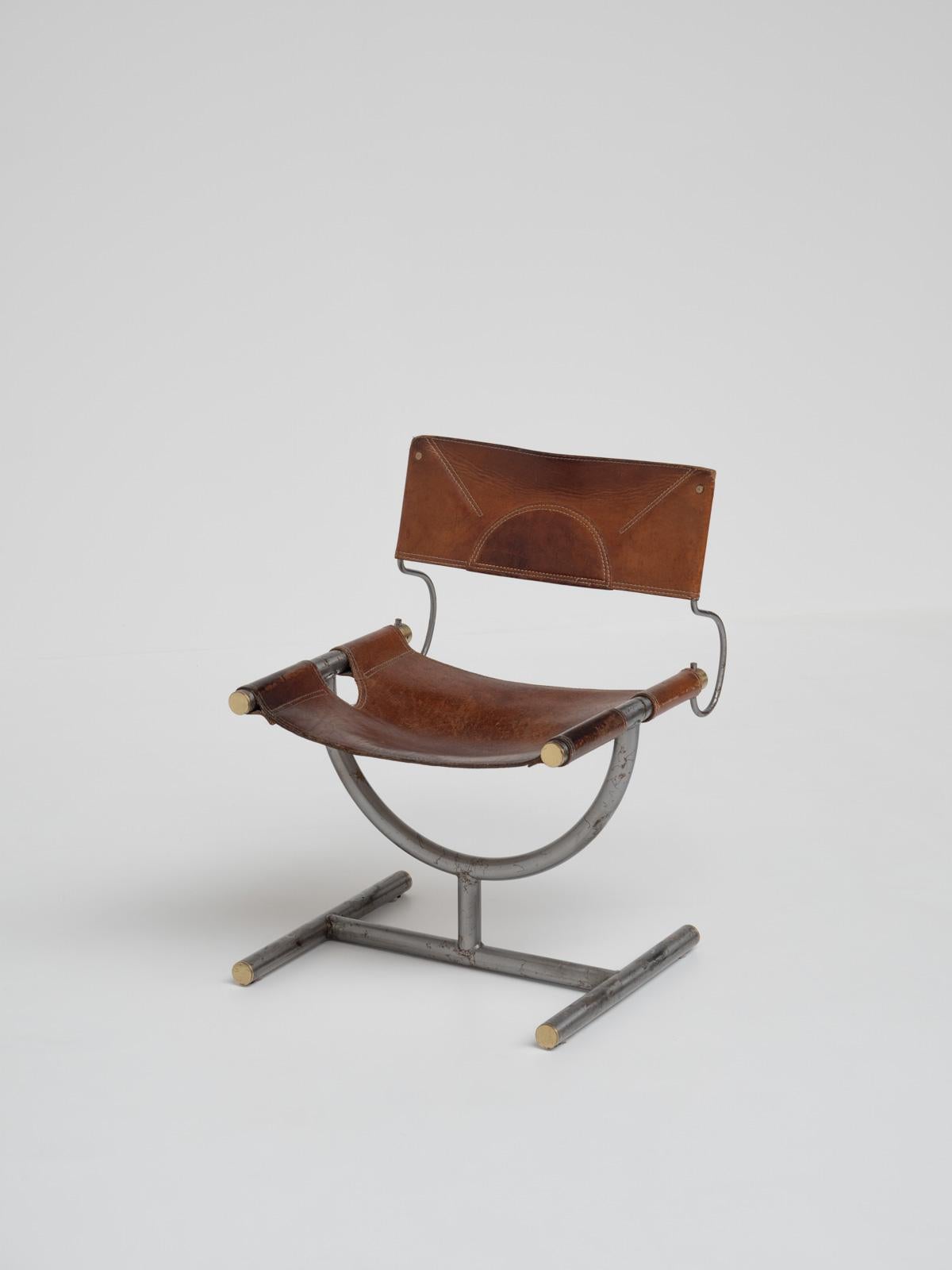 Designed for the Benetton office by the iconic Italian architects Afra & Tobia Scarpa in 1985. Crafted from brass, leather, and steel, it epitomizes the elegance and sophistication of Italian design. 

The chair features its original cognac leather