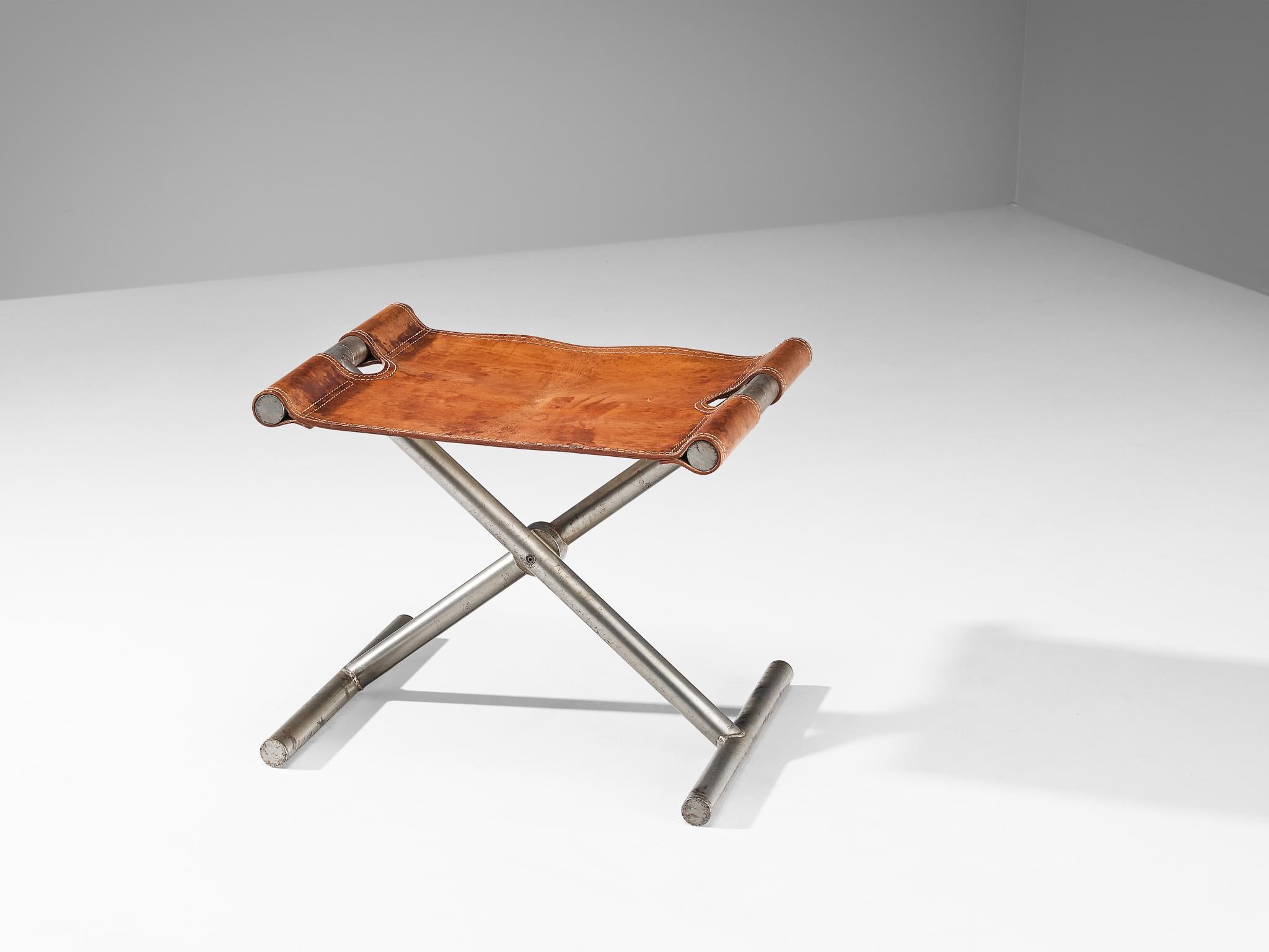 Afra & Tobia Scarpa for Benetton Office, folding stool or ottoman, leather, steel, Italy, 1985.

This rare stool is designed for the office of the clothing brand Benetton by Afra & Tobia Scarpa. Thick cognac leather in patinated condition is