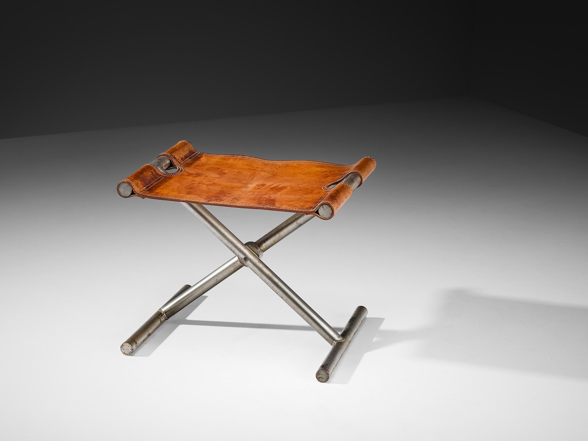 Afra & Tobia Scarpa for Benetton Office, folding stool or ottoman, leather, steel, Italy, 1985.

This stool is designed for the office of the clothing brand Benetton by Afra & Tobia Scarpa. Thick cognac leather in patinated condition is spanned