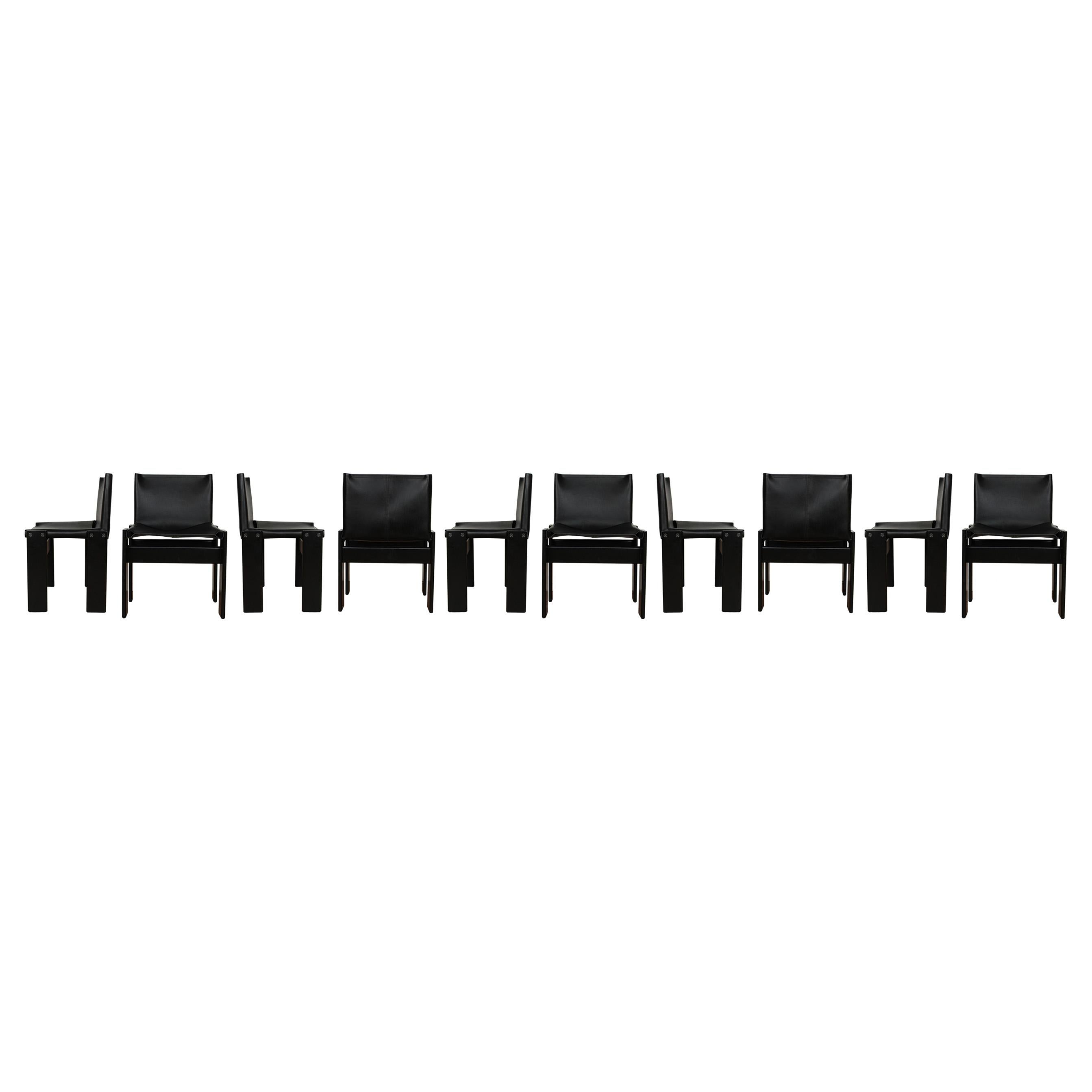 Set of ten “Monk” dining chairs designed by Afra and Tobia Scarpa for Molteni in 1973.
Made of black leather and black lacquered beech wood.
Fully restored in Italy.

Interesting is the ‘flat’ shape of this chair where the designer has chosen to