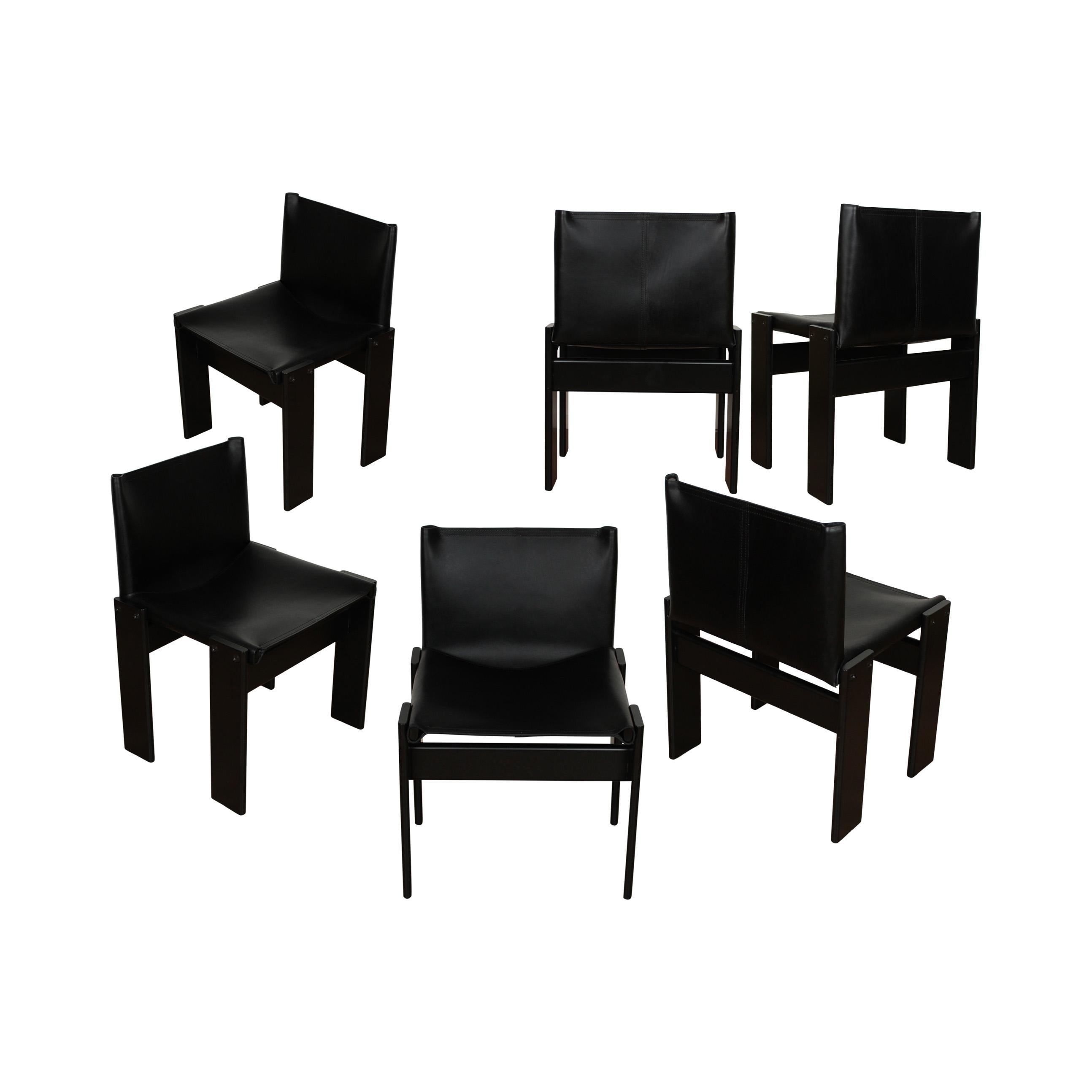 Set of six “Monk” dining chairs designed by Afra and Tobia Scarpa for Molteni in 1973.
Made of black leather and black lacquered beech wood.
Fully restored in Italy.

Interesting is the ‘flat’ shape of this chair where the designer has chosen to