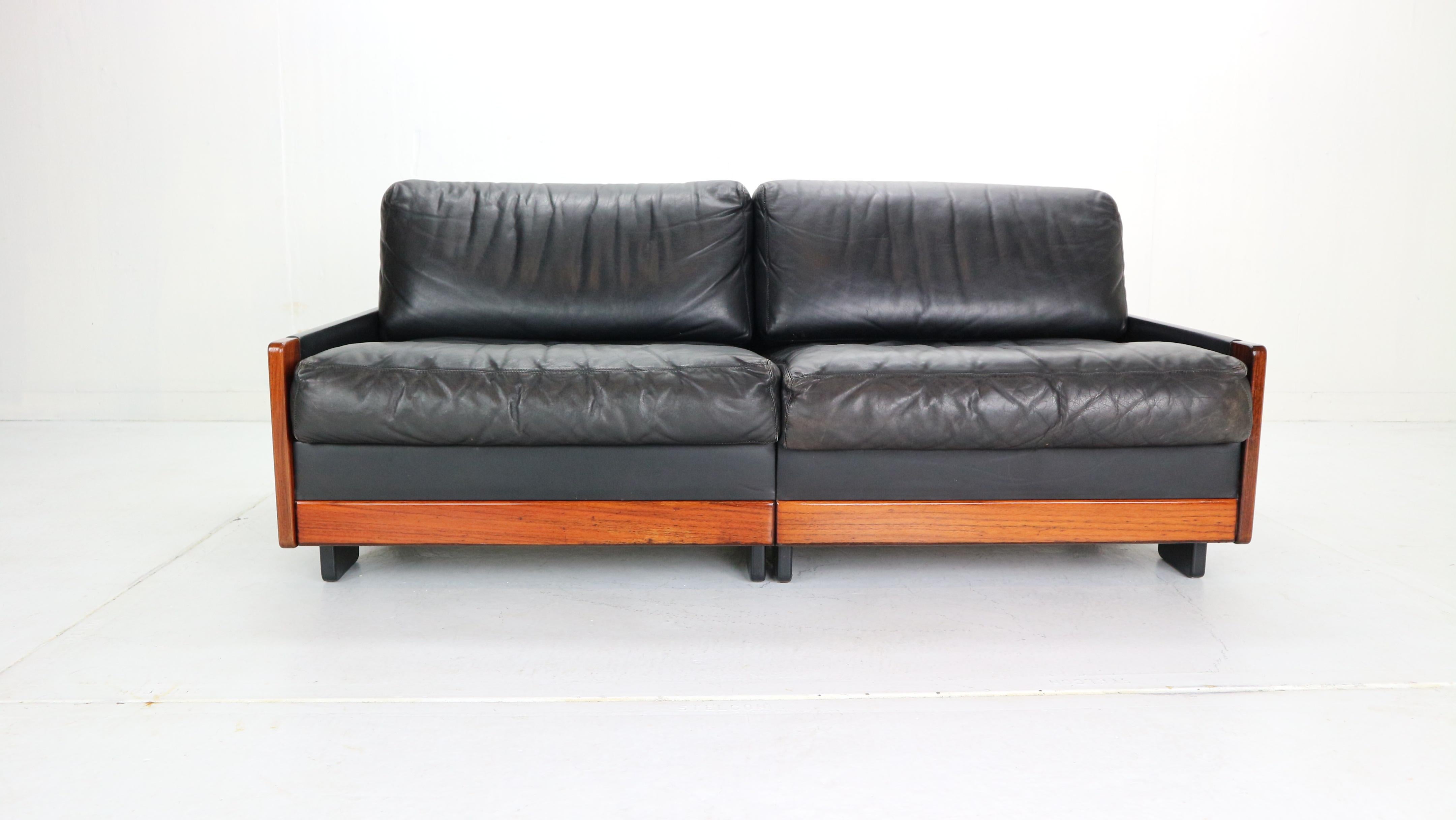 Two-seat sofa was produced by Cassina in 1960s and designed by Afra and Tobia Scarpa.
Mid-Century Modern period Italian design item.
Rosewood frame with a high quality black leather covering the sides, back, seating and back cushions.
Model