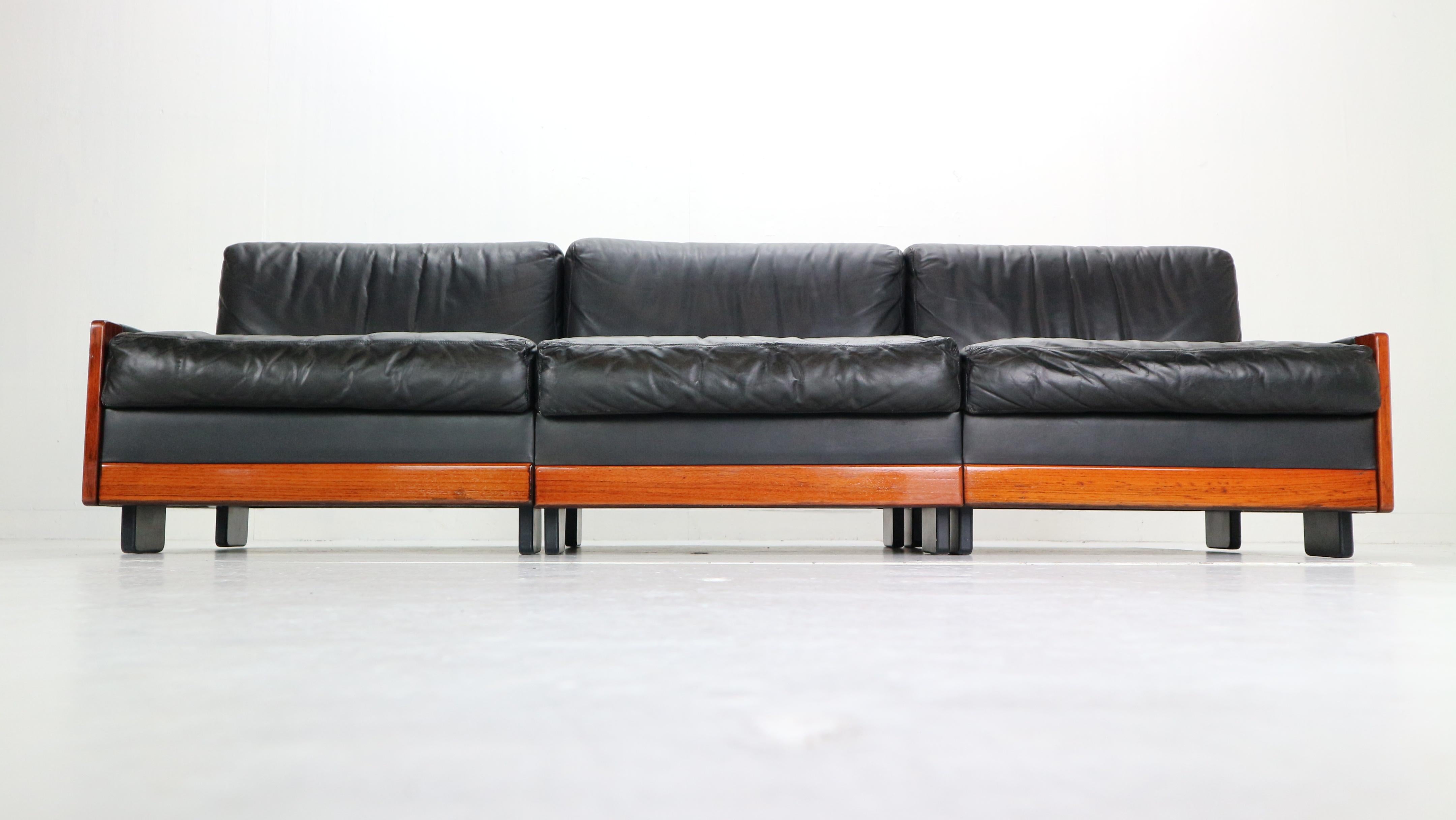 Three-seat sofa was produced by Cassina in 1960s and designed by Afra and Tobia Scarpa.
Mid-Century Modern period Italian design item.
Rosewood frame with a high quality black leather covering the sides, back, seating and back cushions. Has some