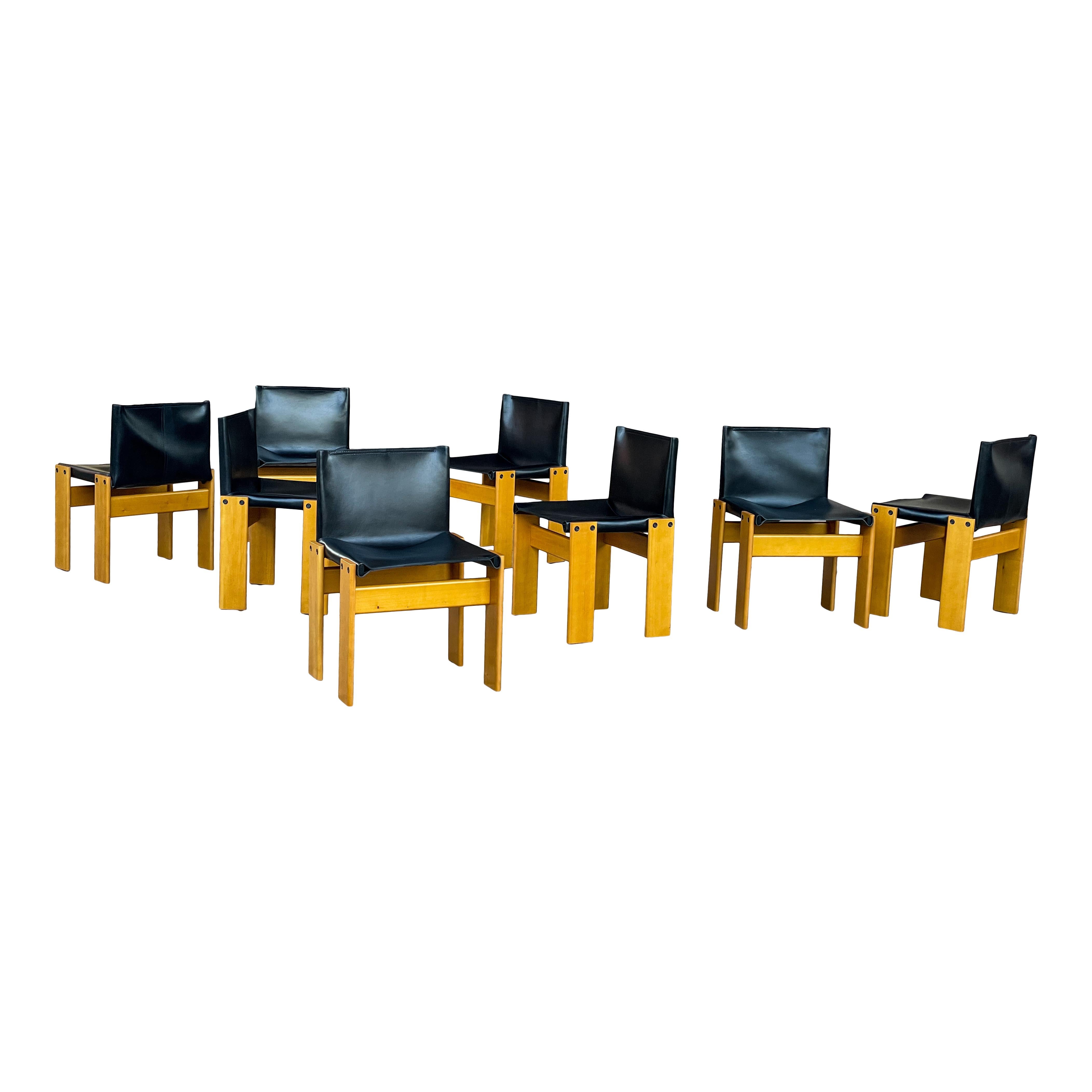 Set of fourteen “Monk” dining chairs designed by Afra and Tobia Scarpa for Molteni in 1973.
Made of black leather and ash wood.
Fully restored in Italy.

Interesting is the ‘flat’ shape of this chair where the designer has chosen to place the
