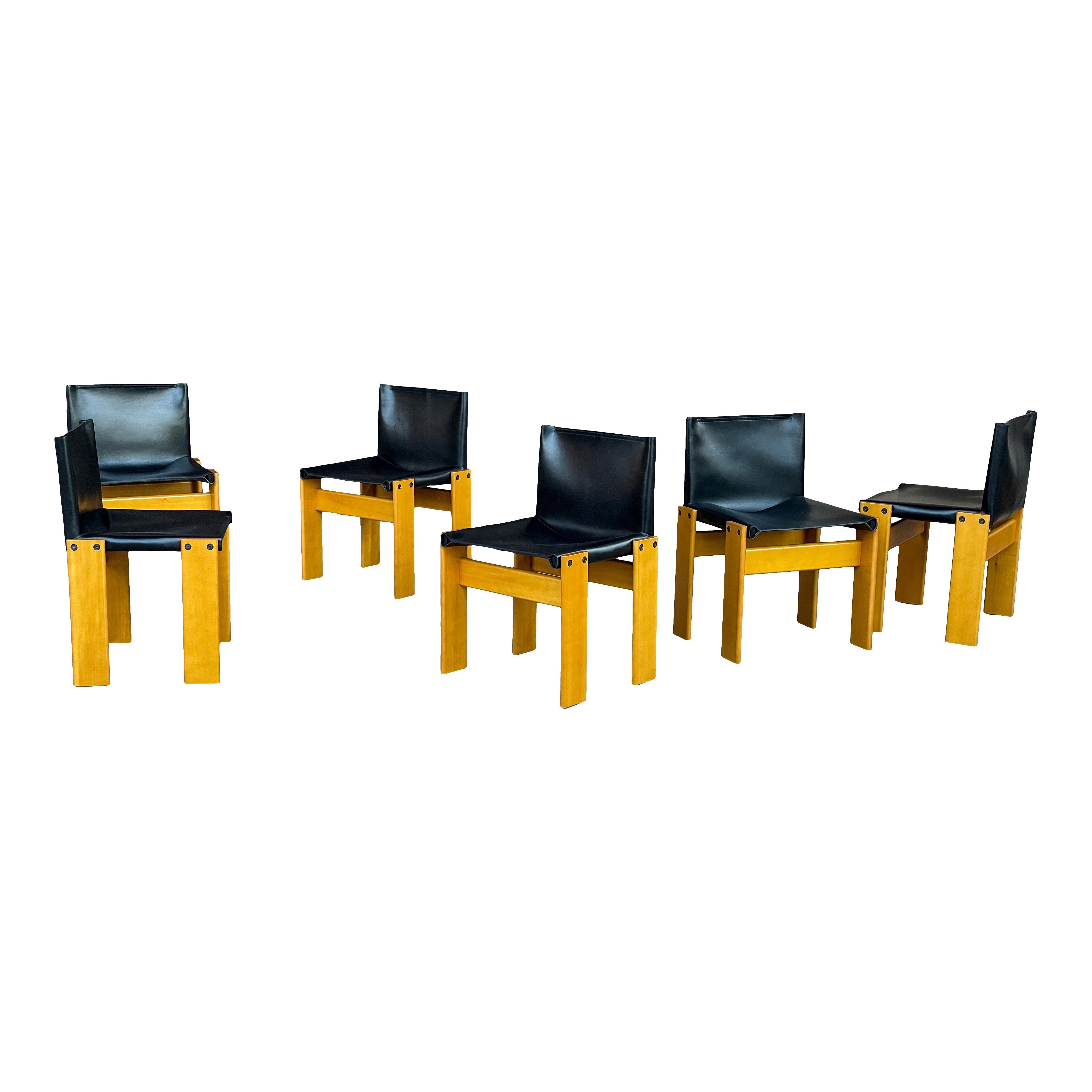 Set of eight “Monk” dining chairs designed by Afra and Tobia Scarpa for Molteni in 1973.
Made of black leather and ash wood.
Fully restored in Italy.

Interesting is the ‘flat’ shape of this chair where the designer has chosen to place the legs