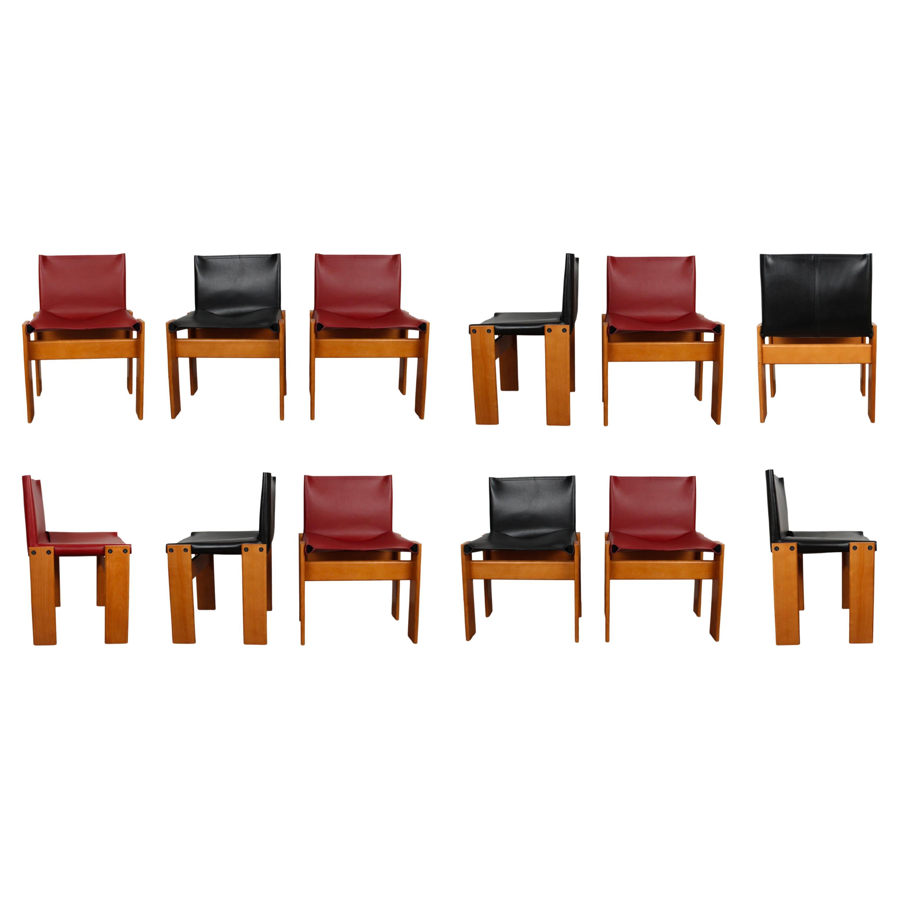 Set of twelve “Monk” dining chairs designed by Afra and Tobia Scarpa for Molteni in 1973.
Made of English red and black leather and walnut.
Fully restored in Italy.

Interesting is the ‘flat’ shape of this chair where the designer has chosen to