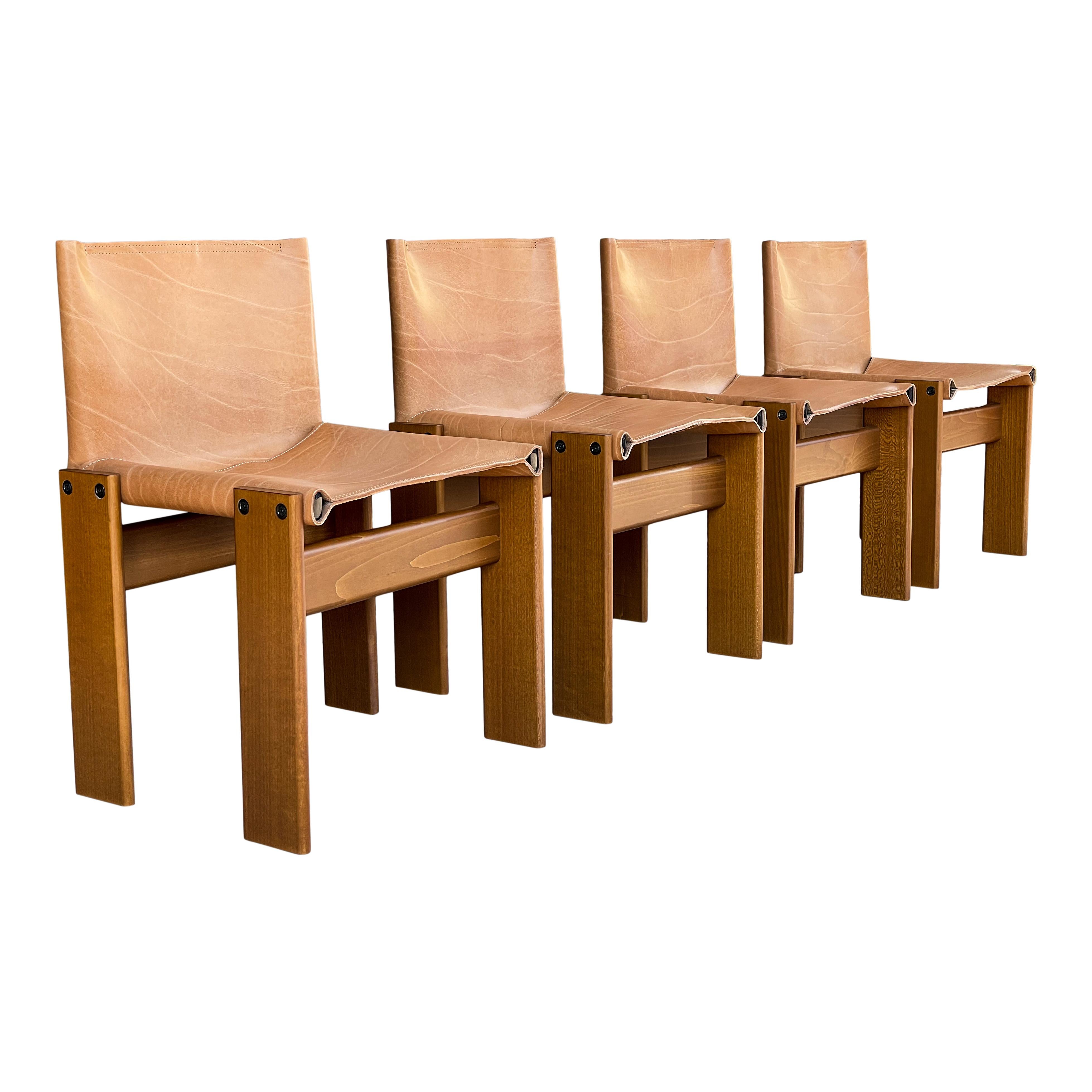Set of four “Monk” dining chairs designed by Afra and Tobia Scarpa for Molteni in 1973.
Made of cognac leather and walnut.
Fully restored in Italy.

Interesting is the ‘flat’ shape of this chair where the designer has chosen to place the legs