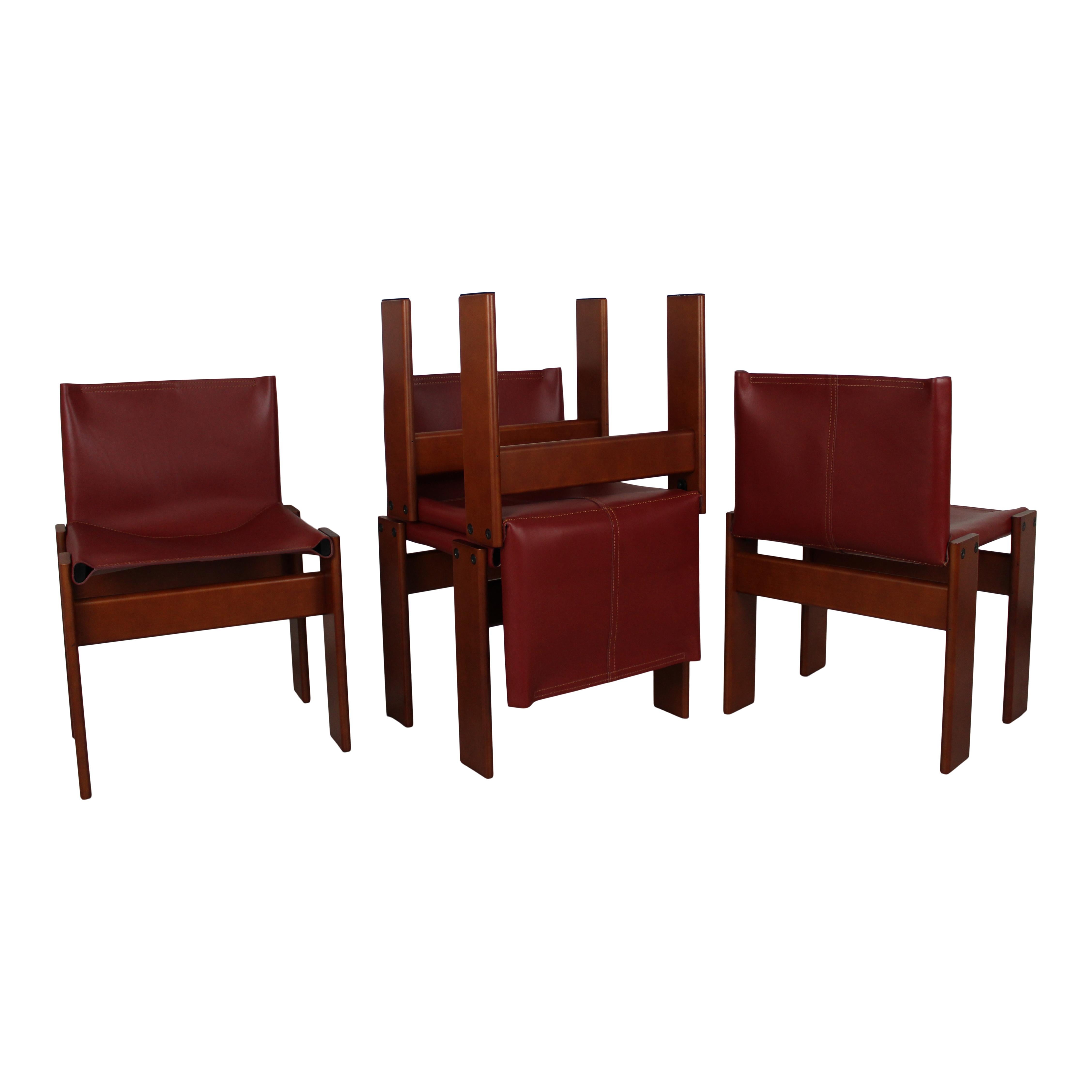 Set of ten “Monk” dining chairs designed by Afra and Tobia Scarpa for Molteni in 1973.
Made of English red leather and walnut.
Fully restored in Italy.

Interesting is the ‘flat’ shape of this chair where the designer has chosen to place the legs