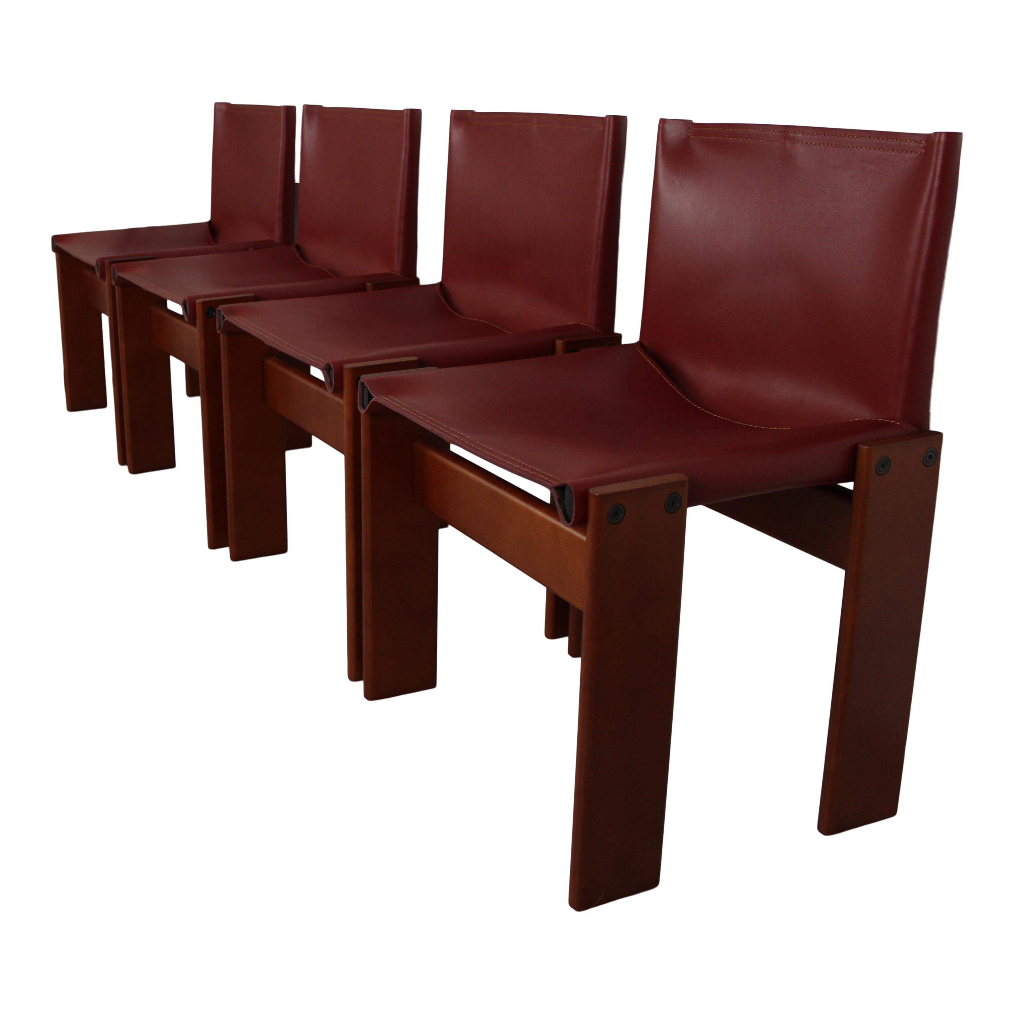 Set of four “Monk” dining chairs designed by Afra and Tobia Scarpa for Molteni in 1973.
Made of English red leather and walnut.
Fully restored in Italy.

Interesting is the ‘flat’ shape of this chair where the designer has chosen to place the legs
