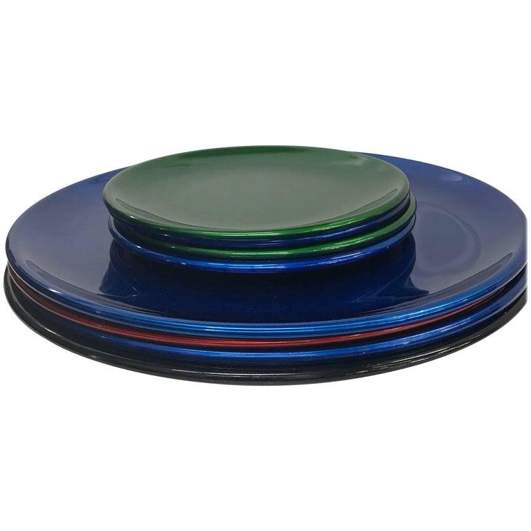 MoMA designers Afra & Tobia Scarpa San Lorenzo Eight Assorted Plates 
blue, green, red and black.
Set of 8 plates: 4 large (1 black 1 red 2 blue) 4 small plates (2 green 2 blue)
Large 13 diameter Small 8 diameter
Stamped by maker 
Glazed aluminum