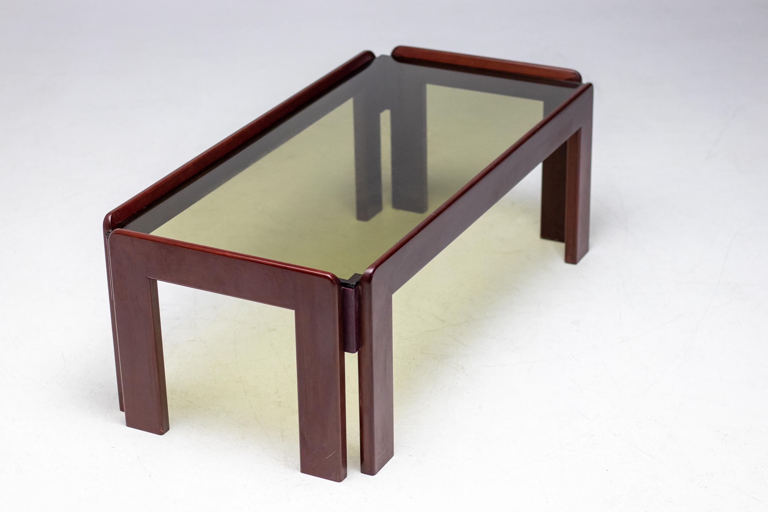 Elegant mahogany coffee table with smoked glass top designed by Afra & Tobia Scarpa for Cassina. 

Chic, distinctive, and cool, the work of husband-and-wife-team Tobia and Afra Scarpa has found a new generation of sophisticated admirers in the 21st