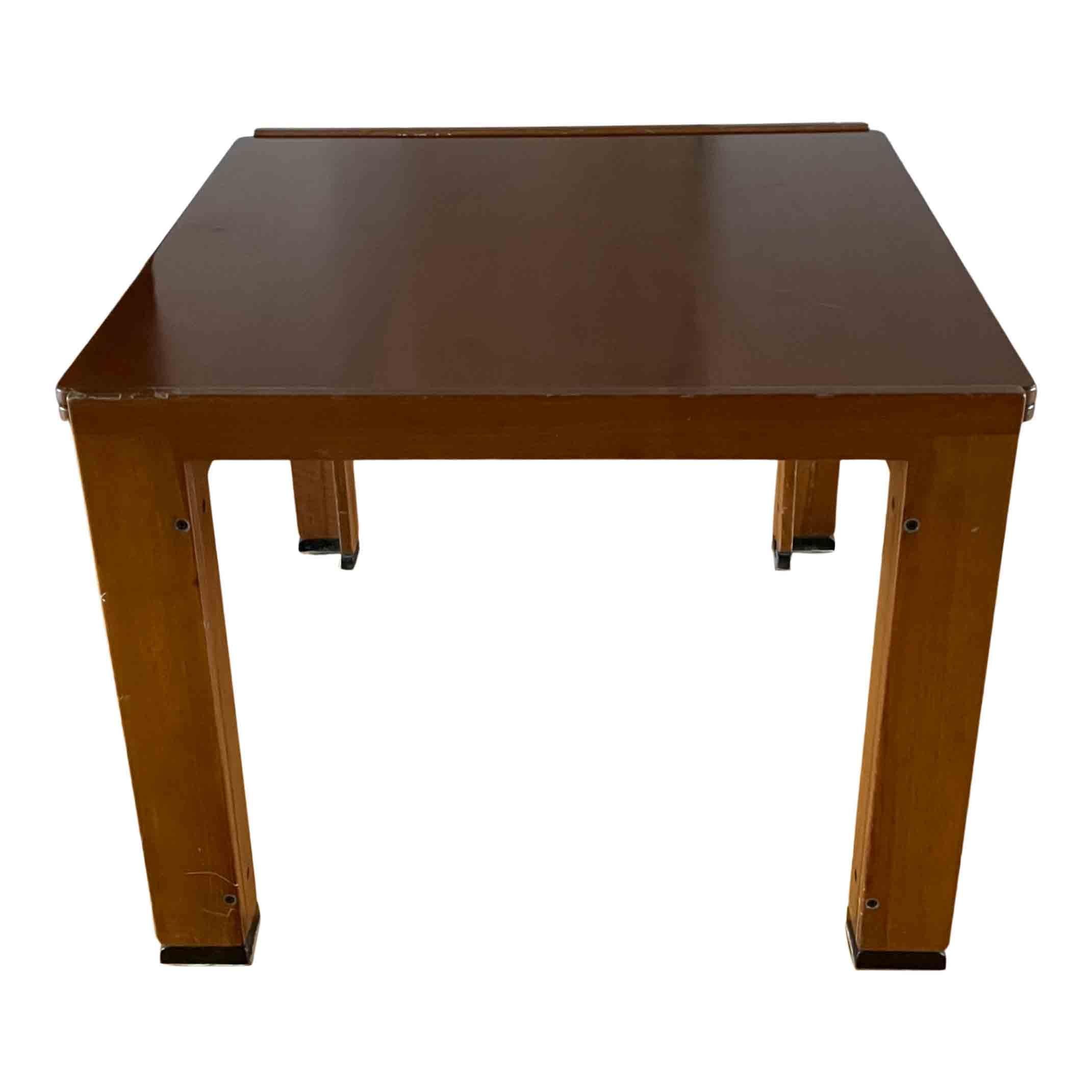The “778” model is an example of solid wood boards arranged to form a C-shaped frame. The table, with a top that opens, is supported by four trestles, two of which are a few centimeters lower than the others so that the top can rest on them when the