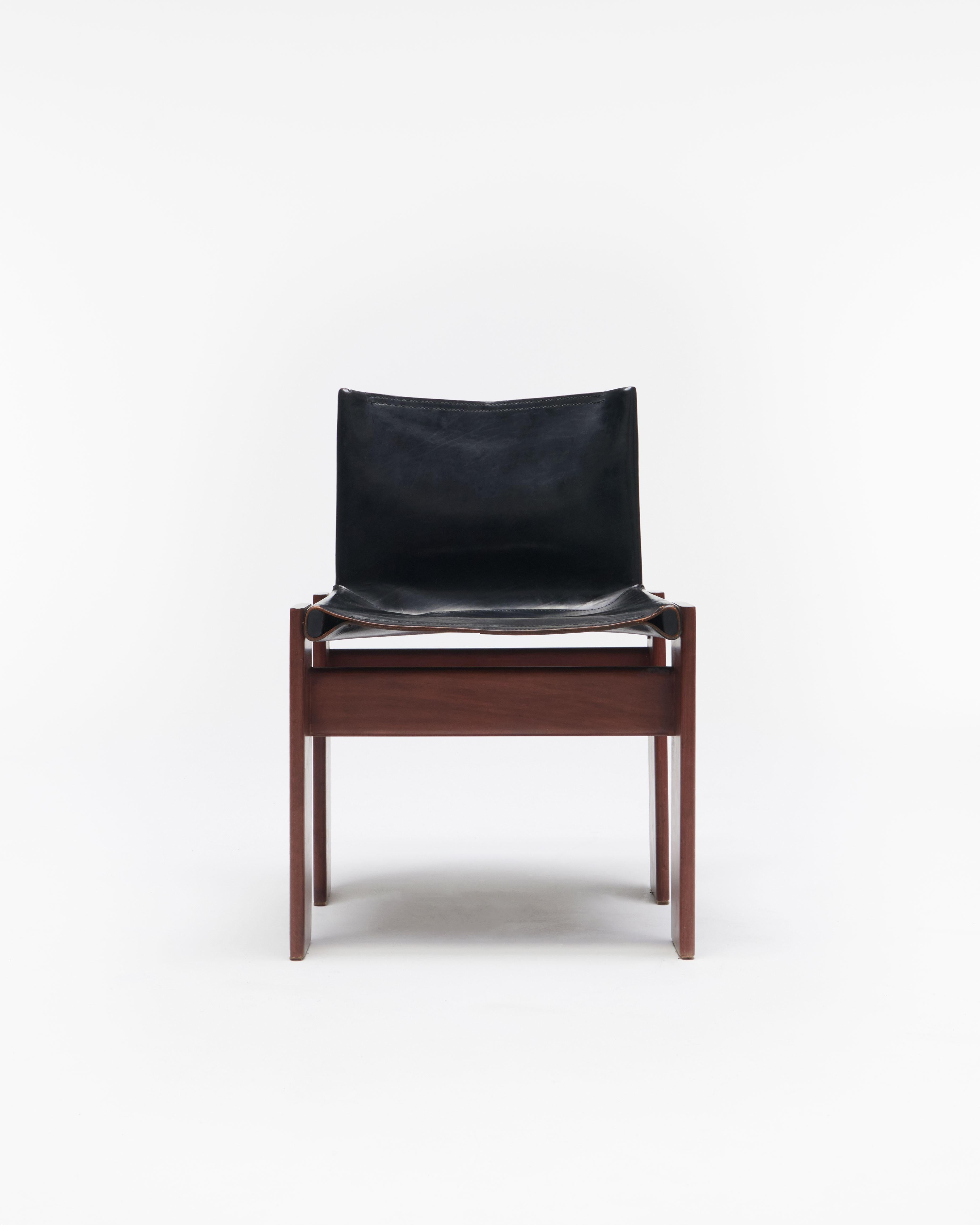A set of 2 Monk chairs designed by the formidable husband-and-wife duo Tobia and Afra Scarpa, renowned for their work that harmonizes materials, technology, and aesthetics. The chairs were sourced from the original owner, who purchased them in 1981