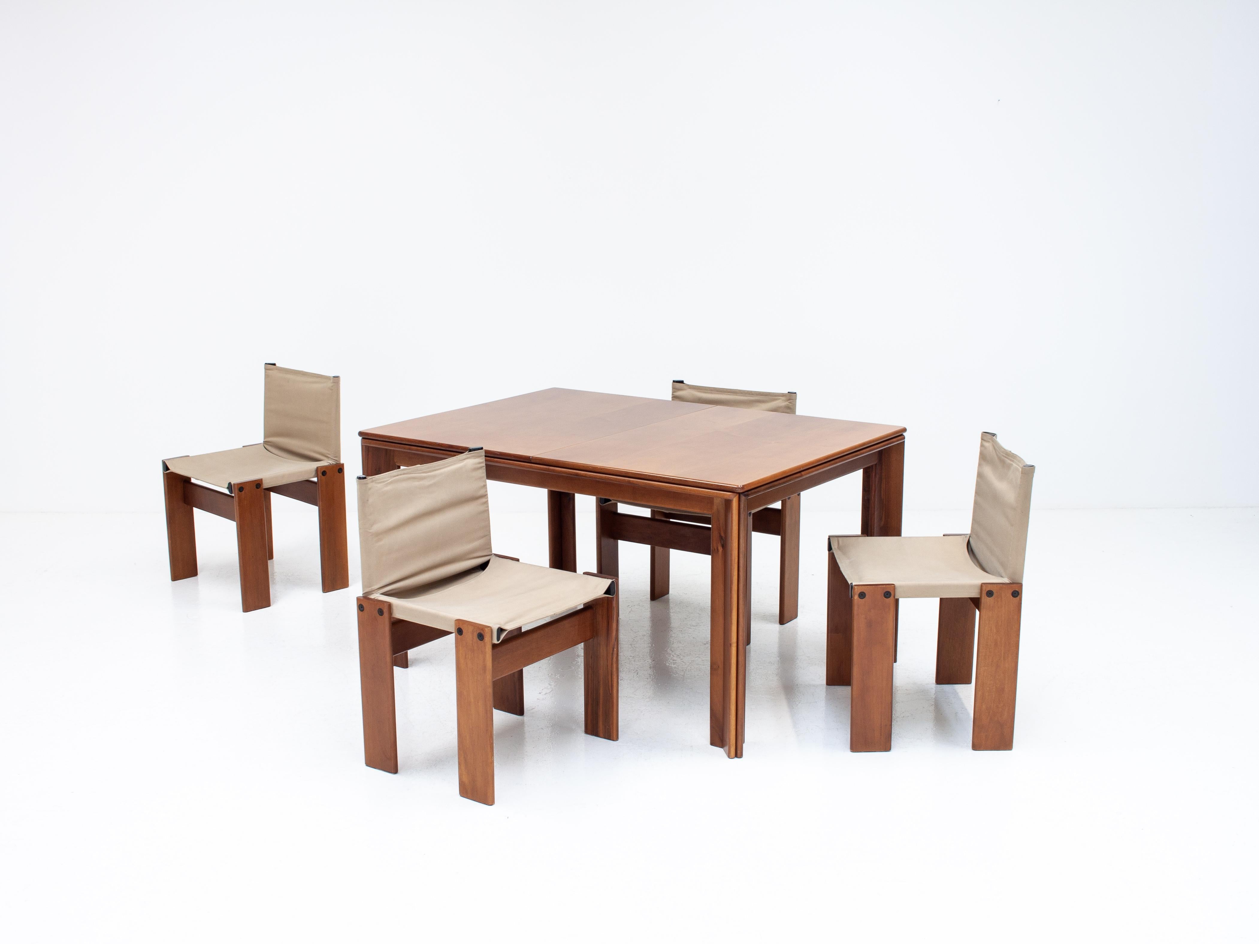 A set of 'Monk' dining chairs & table by Italian award-winning designer couple Afra & Tobia Scarpa. 

With Walnut wood and canvas, the design is high-quality, minimal and solid. Manufactured by Molteni, Italy, 1974. 

A stunning set and rare to be