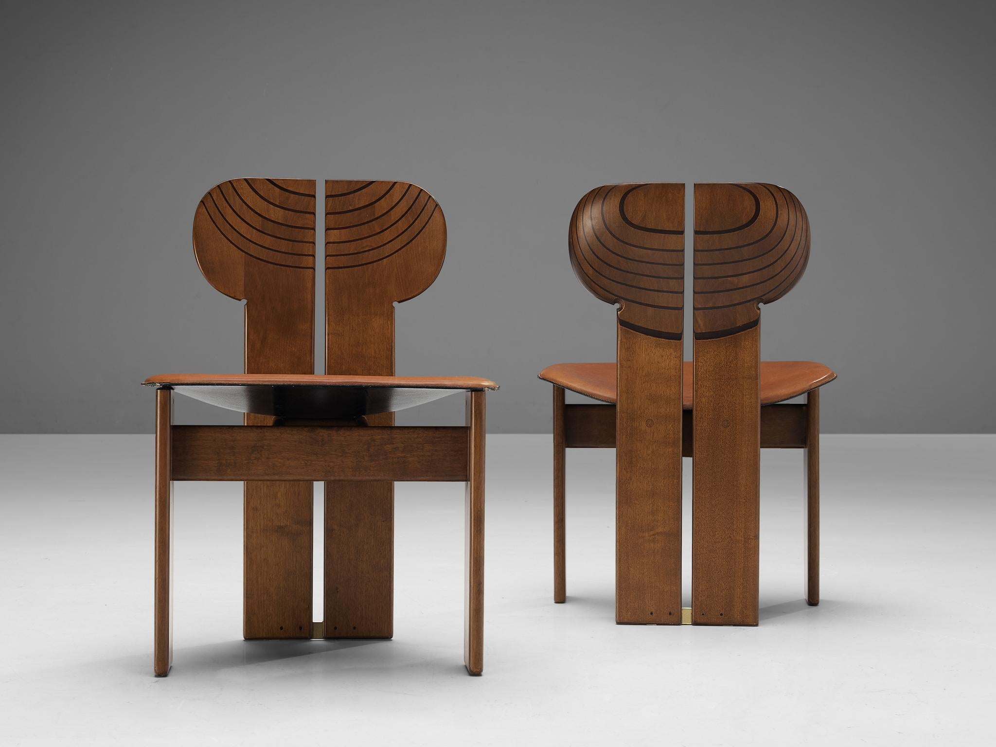 Afra & Tobia Scarpa for Maxalto, dining chairs model 'Africa', cognac leather, in walnut, ebony and brass, Italy, 1975.

This pair of 'Africa' chairs explicitly sculptural grand chairs is designed by Afra & Tobia Scarpa. They are part of the